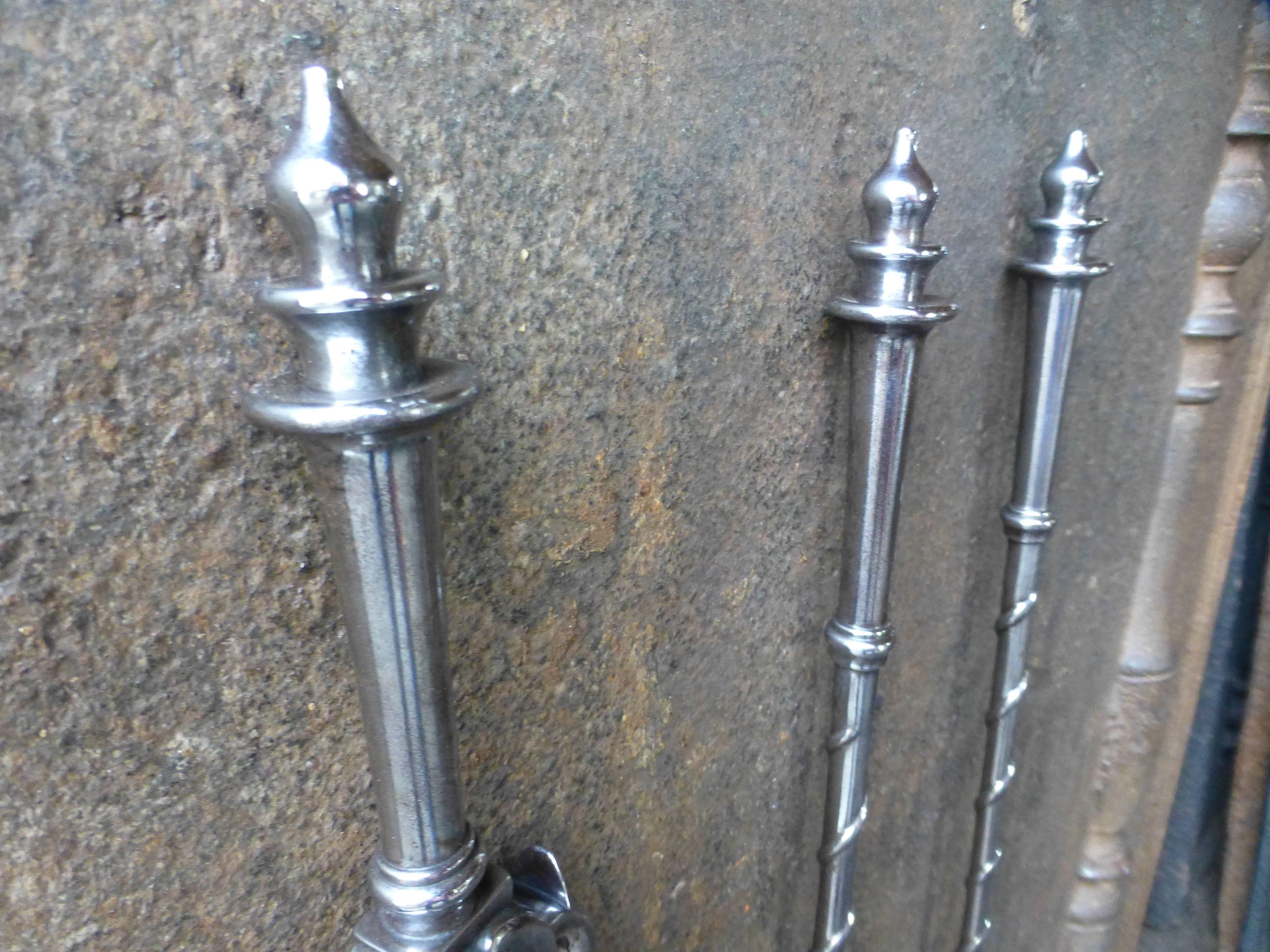 19th century English fire tools, fire irons made of polished steel.