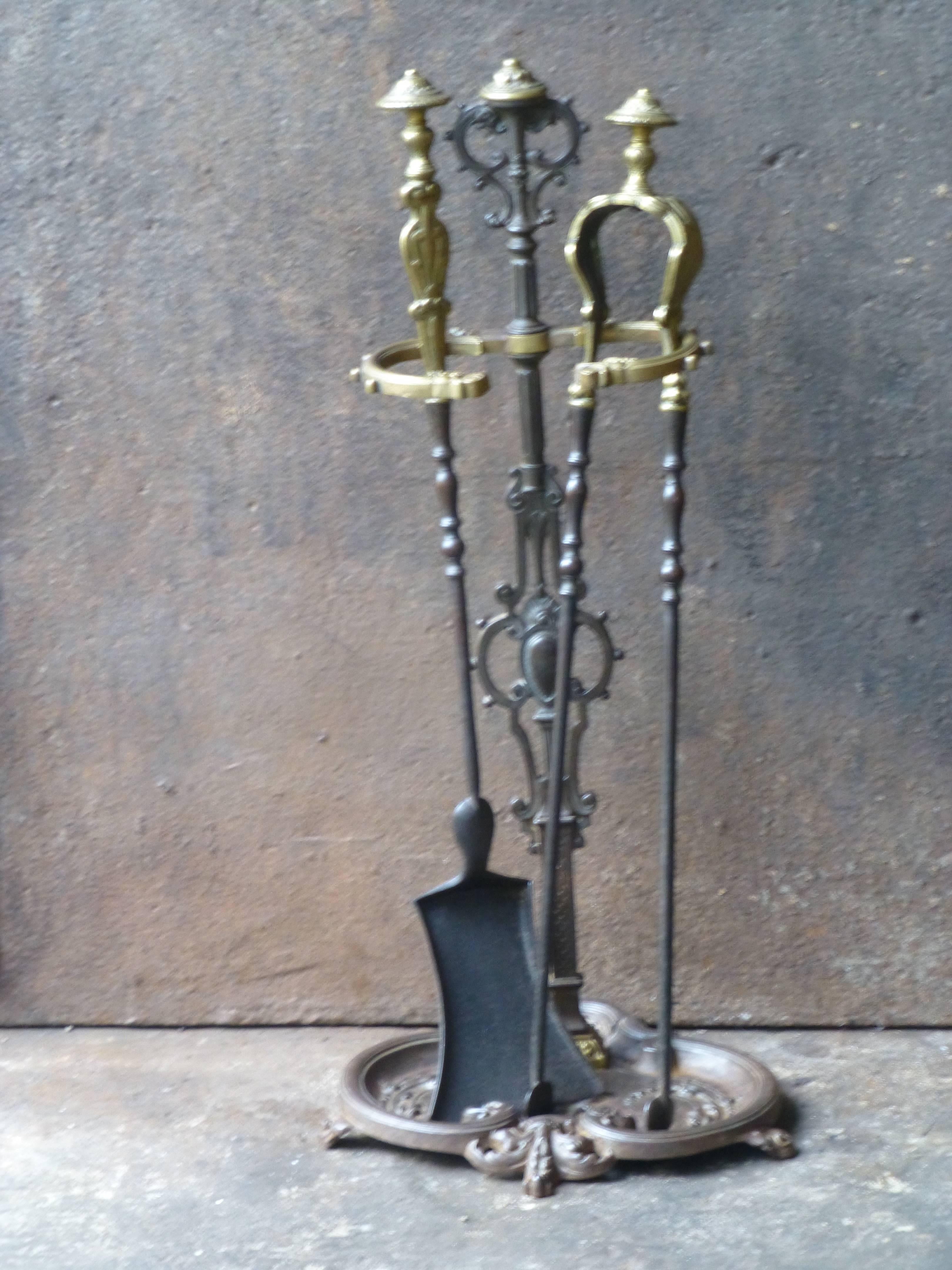 19th century French fireplace tool set made of wrought iron (tools) and cast iron and brass (stand).