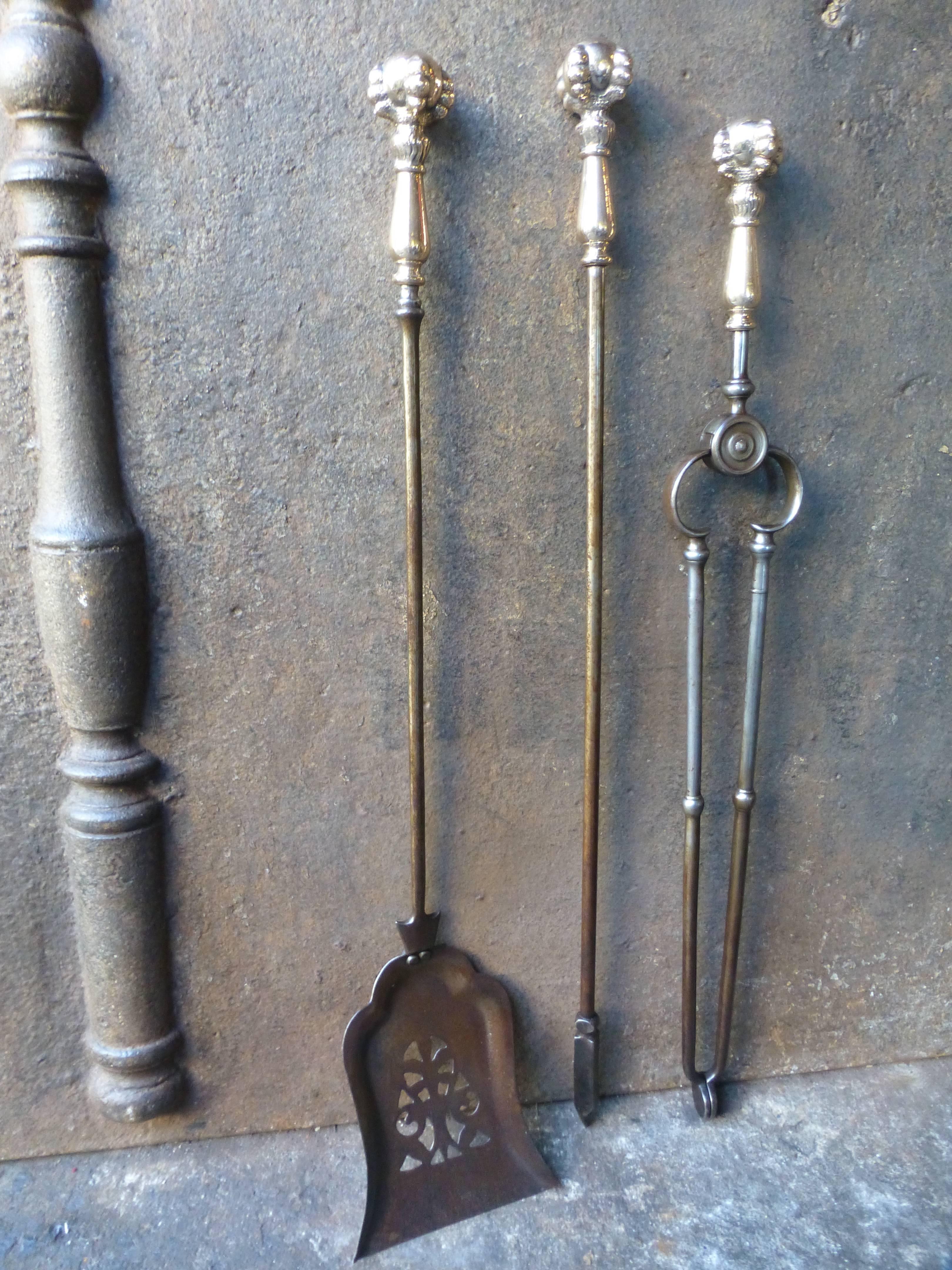 19th century English fireplace tool set made of bronze, polished copper and wrought iron.