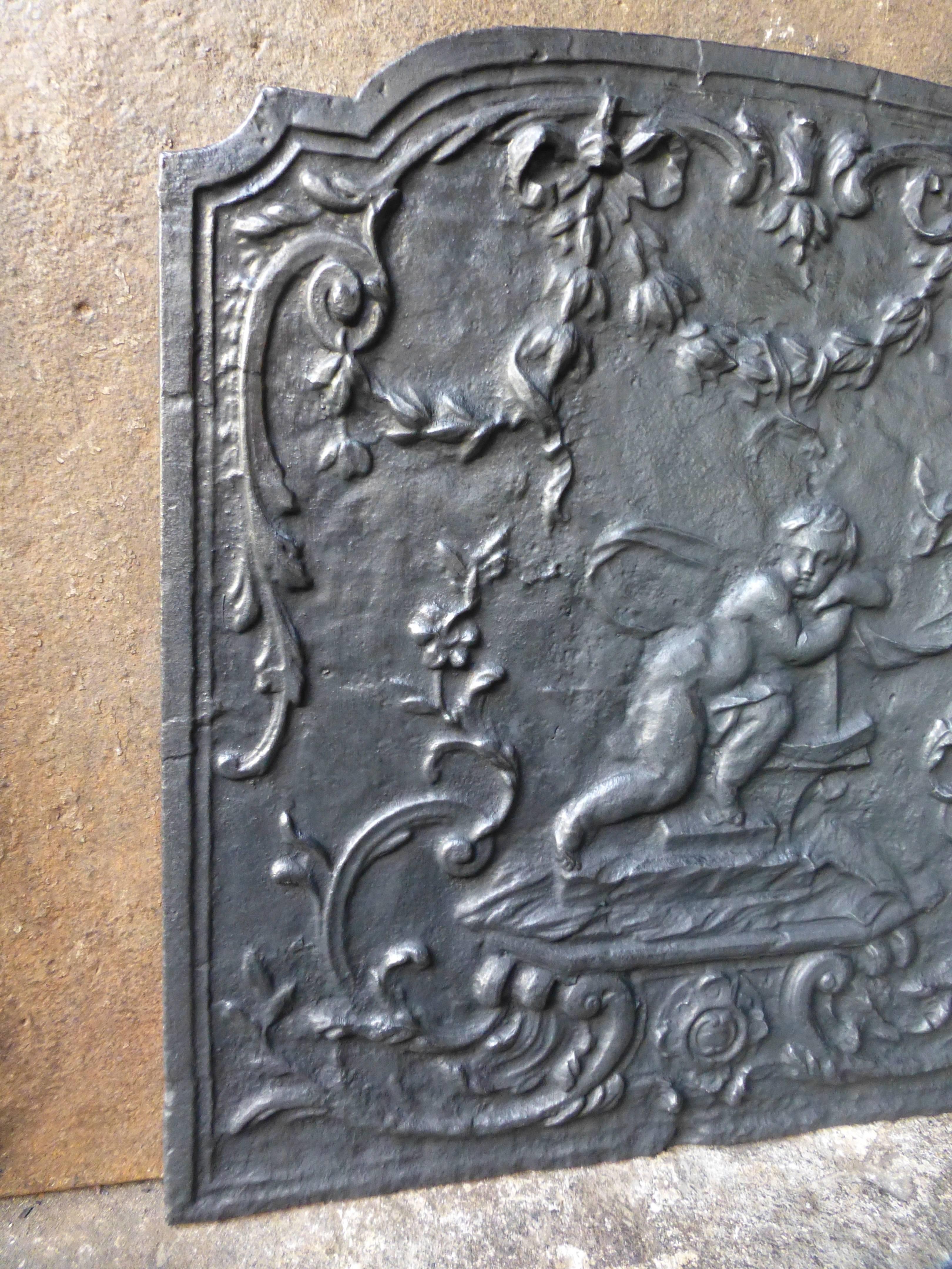 18th century French fireback with a cupid.