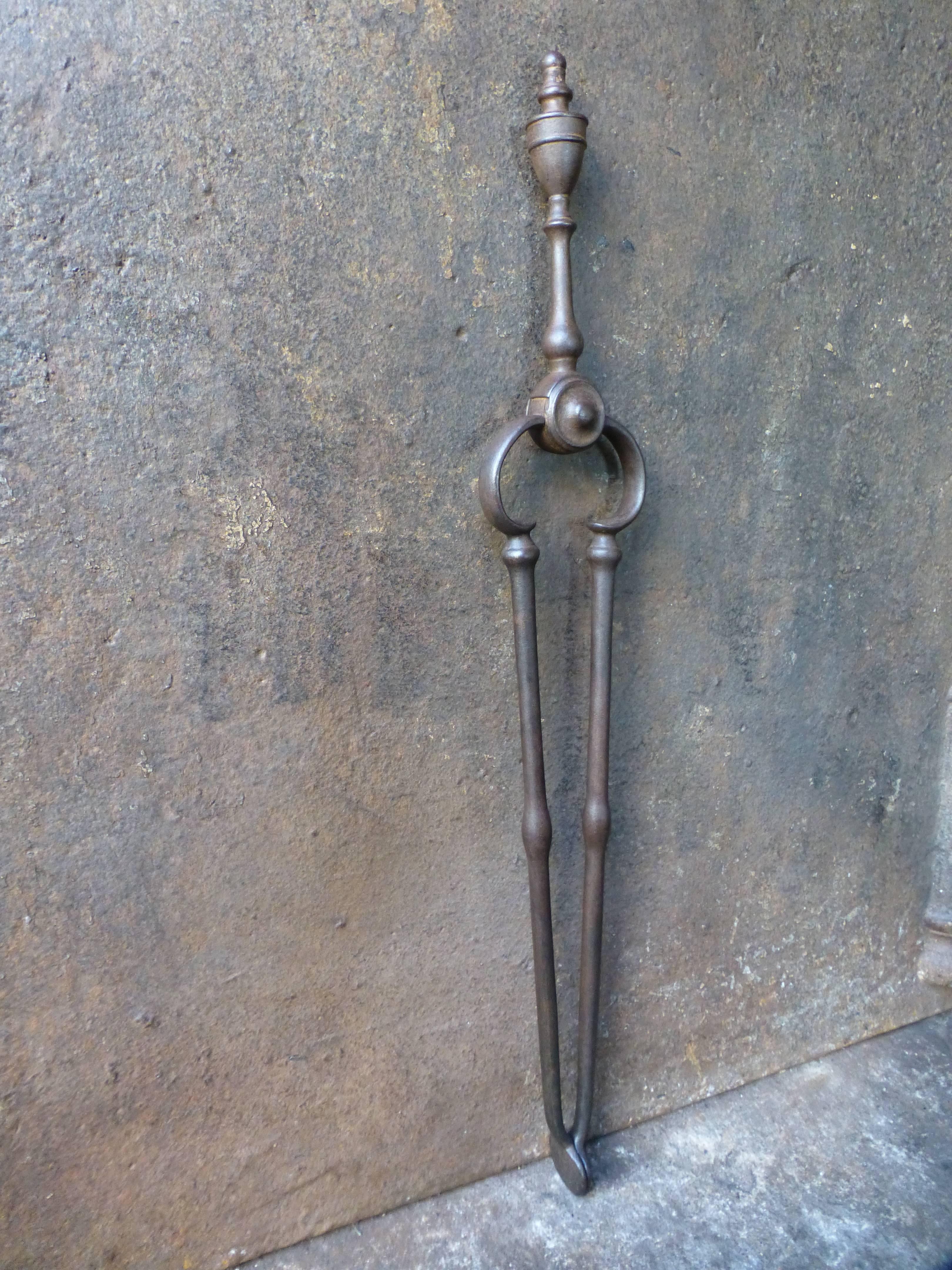 19th century English fireplace tongs made of wrought iron.