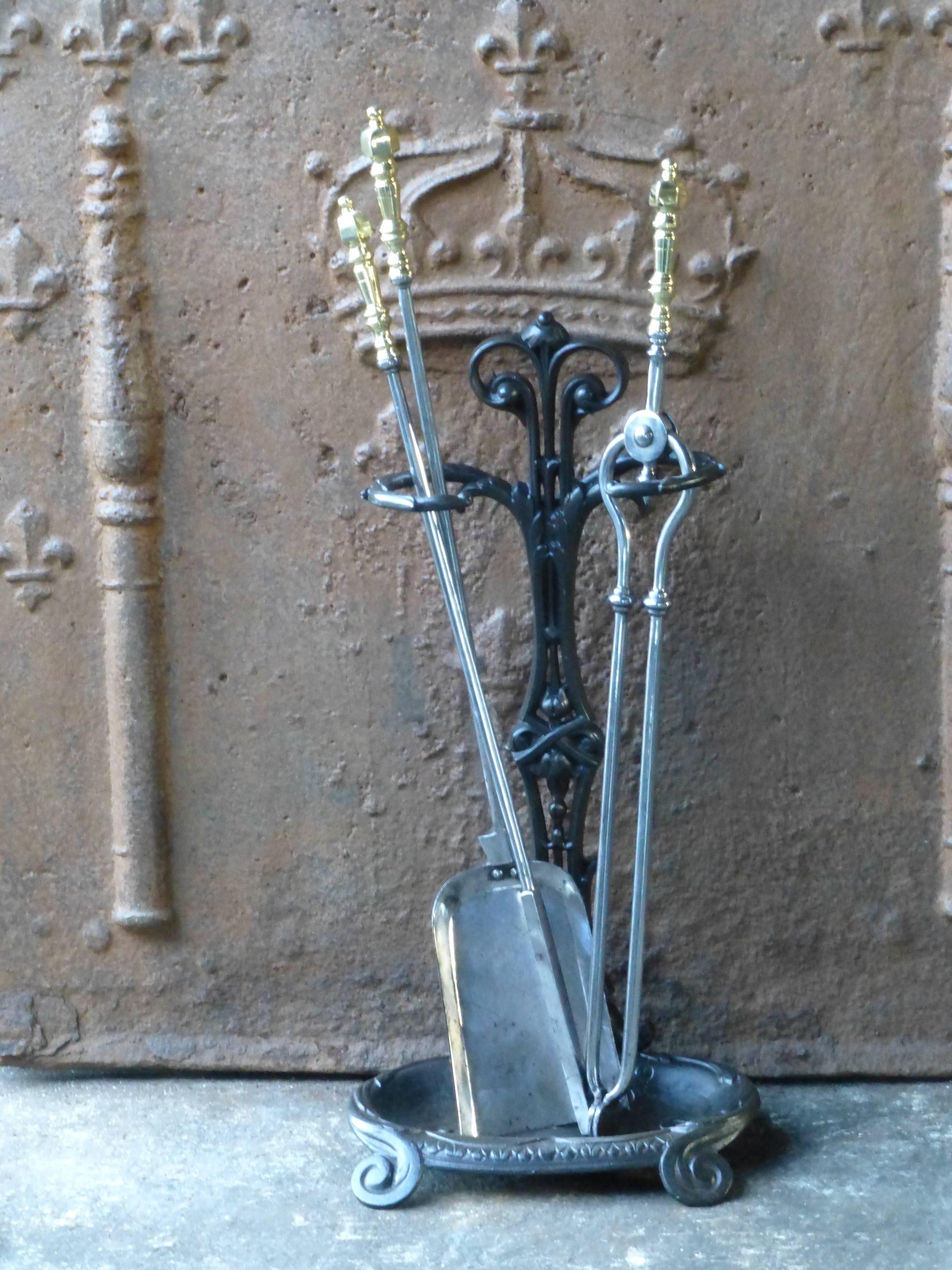 19th century English fireplace toolset made of cast iron, polished steel and polished brass.
