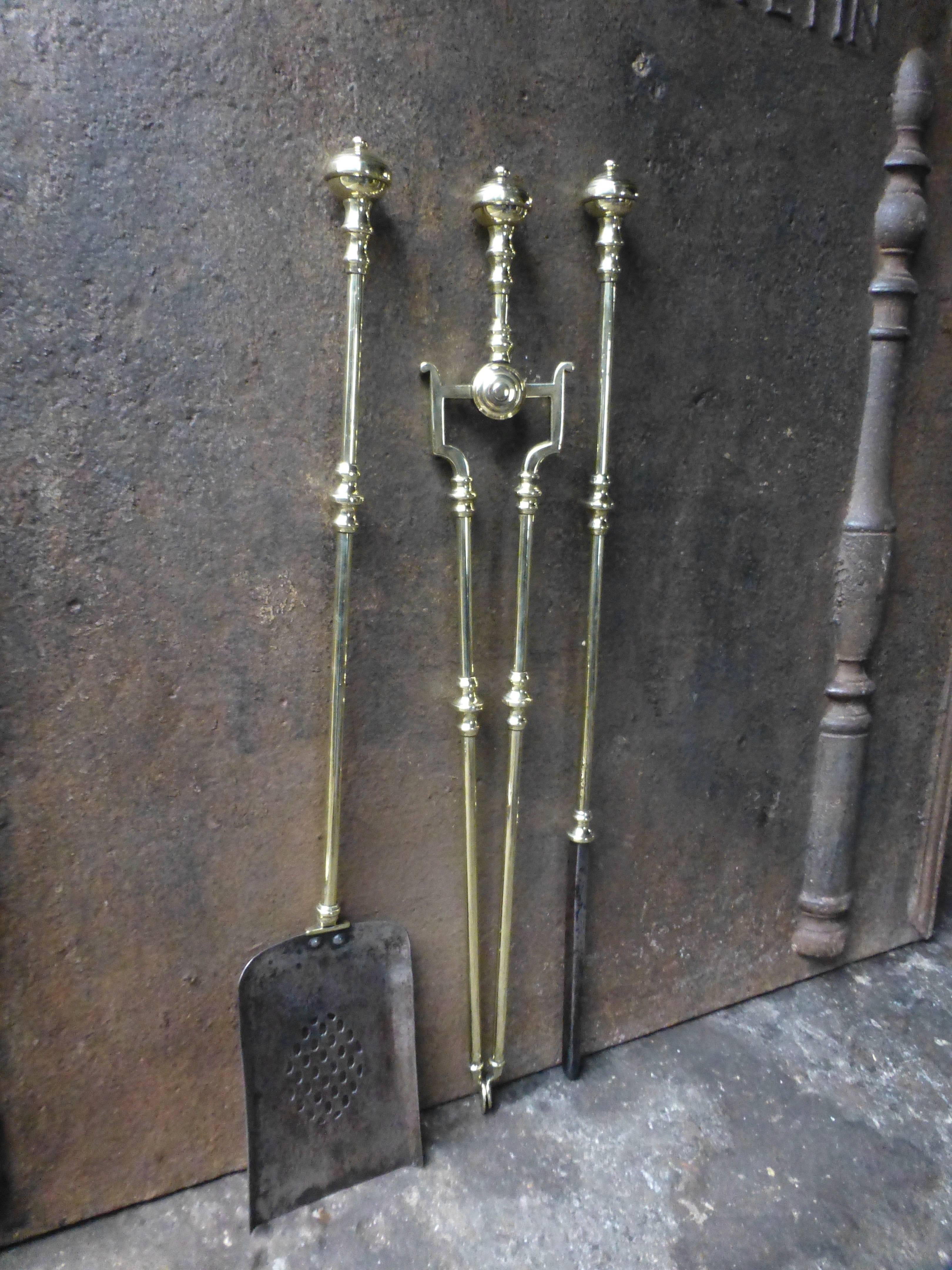 English fireplace tool set made of polished brass.