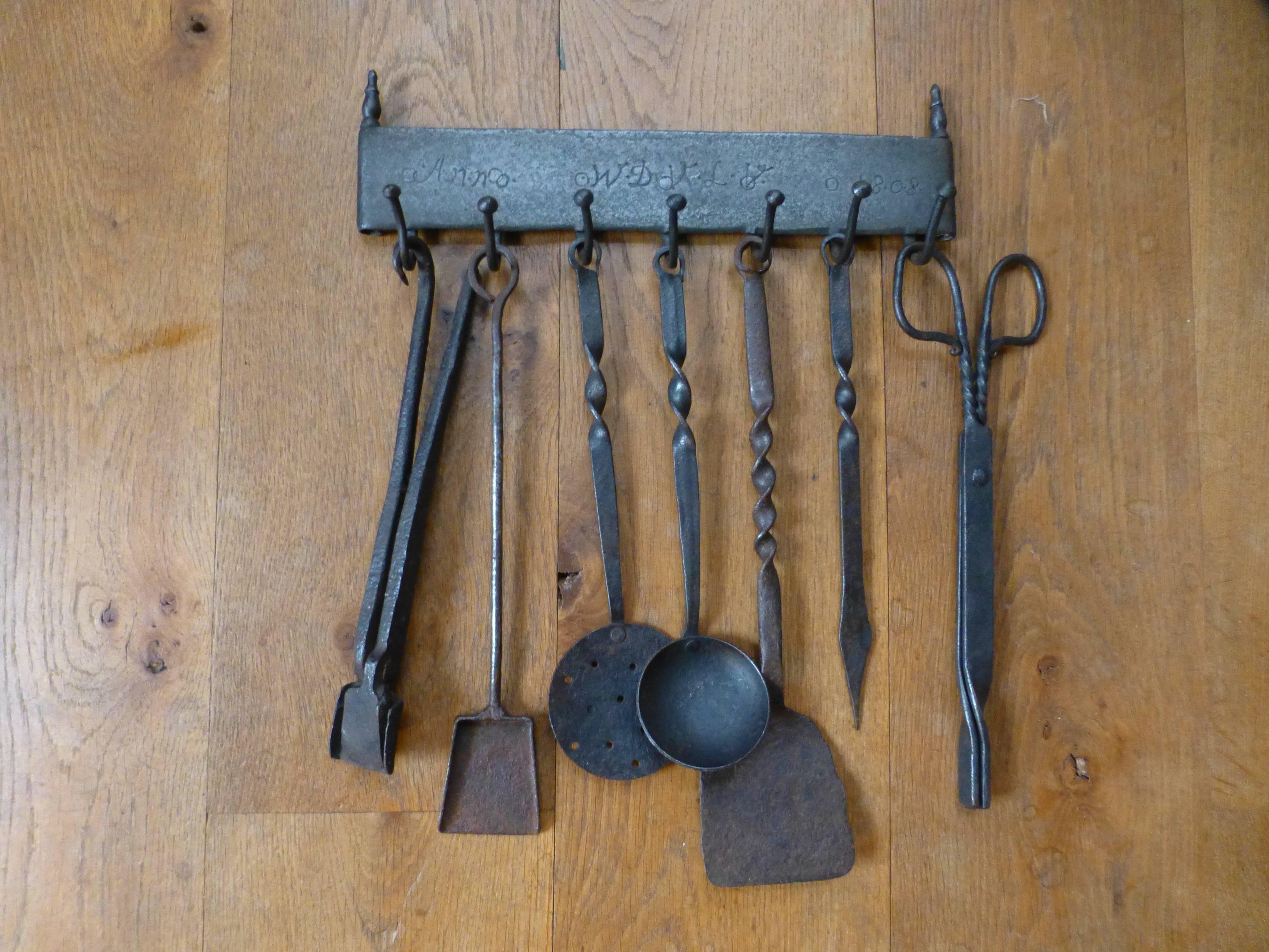 18th-19th century Dutch fireplace tools used for cooking in an open fire. Set of seven tools and a hanger all made of wrought iron.

We have a unique and specialized collection of antique and used fireplace accessories consisting of more than 1000
