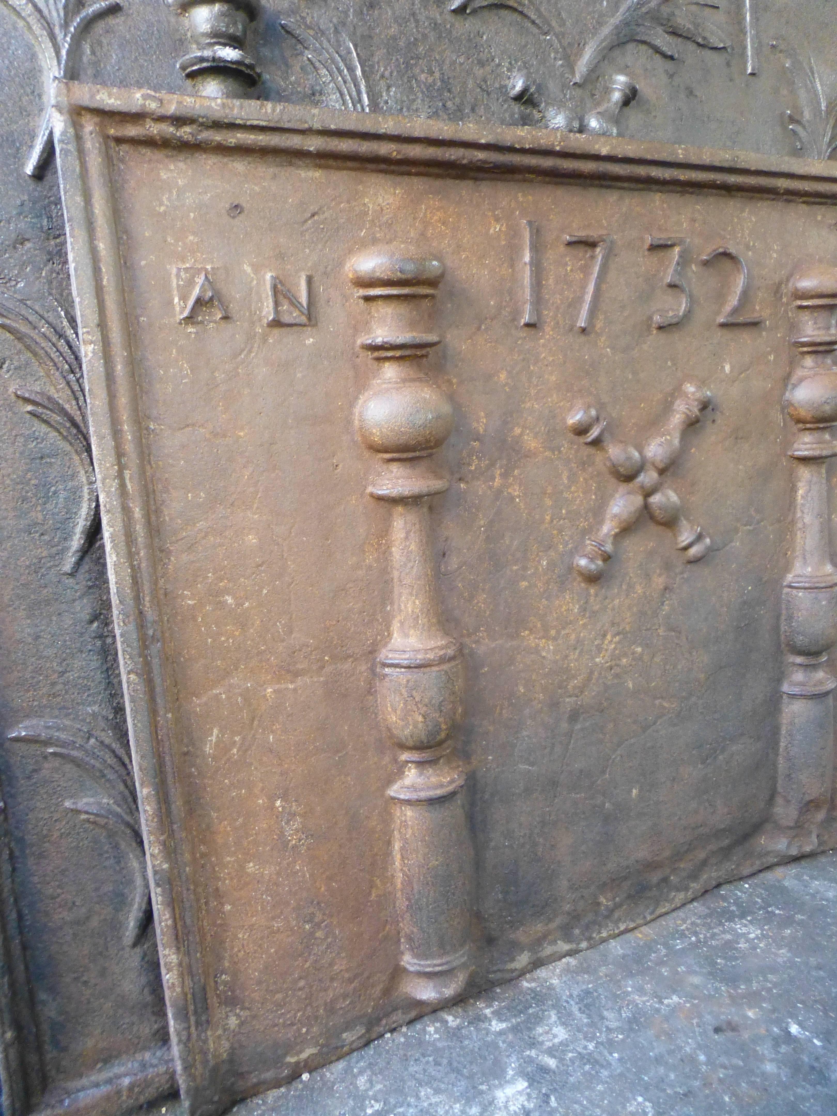 French fireback with pillars, the cross of Saint Andrew and the date of production 1732.

Saint Andrew is said to have been martyred on a cross in this shape. It appears in numerous flags such as Saint Patrick's flag, the Spanish flag and the Arms