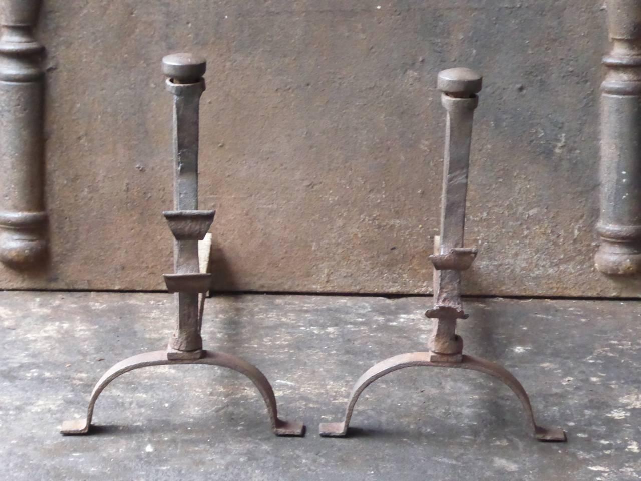 18th century French andirons with spit hooks to grill food.