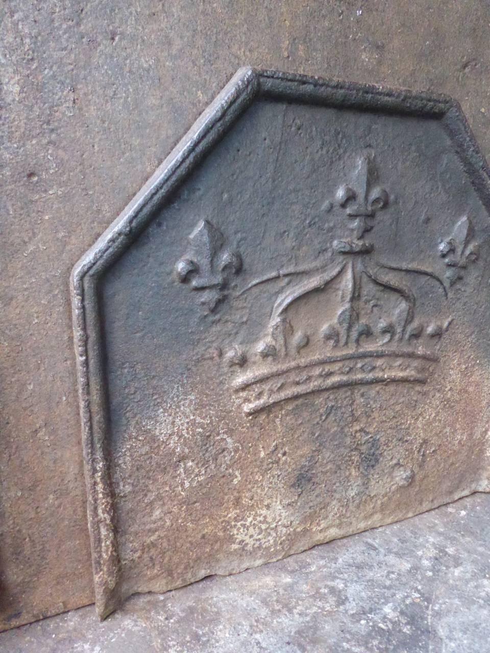 17th-18th century French fireback with a crown and three Fleurs-de-Lis. 

The Fleur-de-Lis is a symbol for purity and appeared on many coats of arms and flags throughout Europe. It is especially used by the house of Bourbon which provided kings