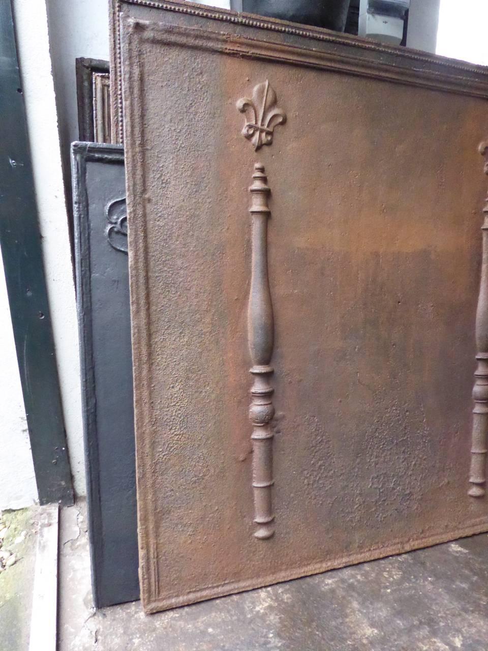 18th century French fireback with pillars and fleur-de-lis.

Fleur-de-lis (lilies) are symbols for purity. They were often used by royalty and aristocracy around Europe and specifically by the House of Bourbon.

The pillar refers to the club of