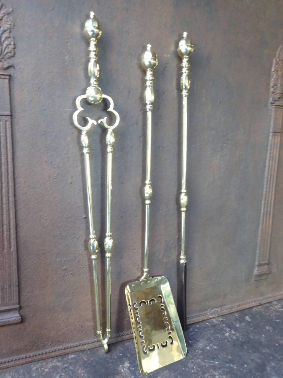19th century English fireplace tool set made of polished brass and polished steel.