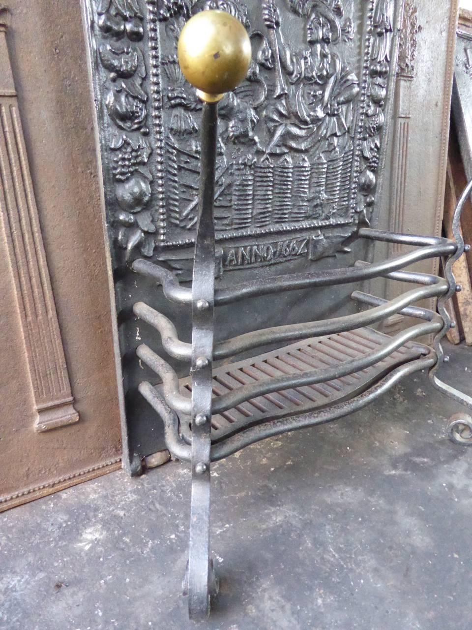 19th century Dutch fireplace grate made of cast iron, wrought iron and brass. 

The back of the grate symbolizes the young Dutch Republic. This picture was from about 1580 onwards the standard motive for the liberation of the Seven United