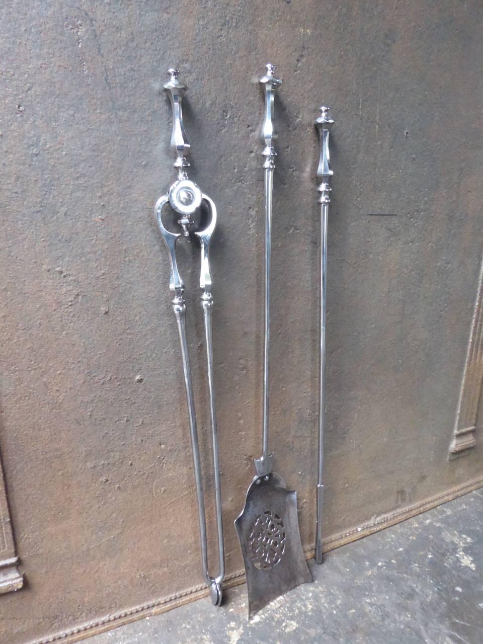 19th century English fireplace tool set, fire irons made of polished steel.