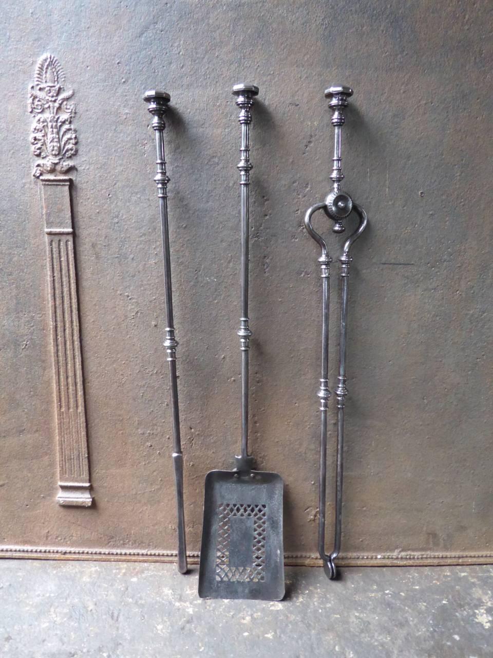 19th century English fireplace tools made of polished steel.