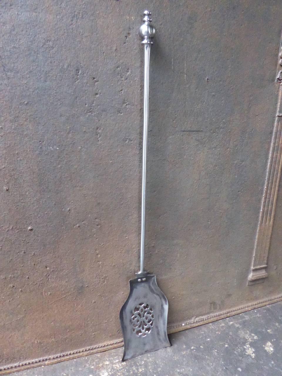 19th century English fire shovel made of polished steel.
