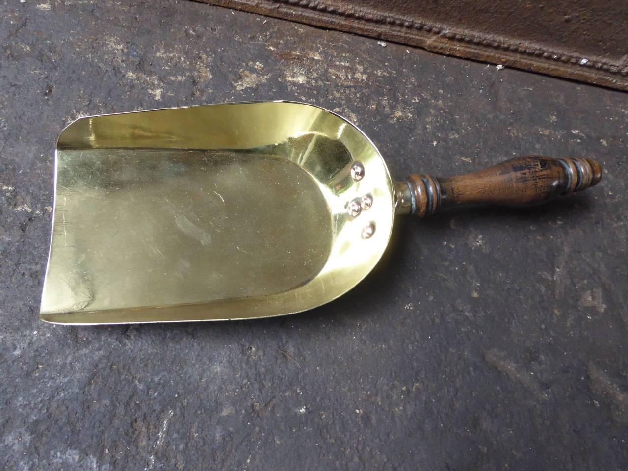 19th century English fireshovel made of polished brass, polished copper and wood.