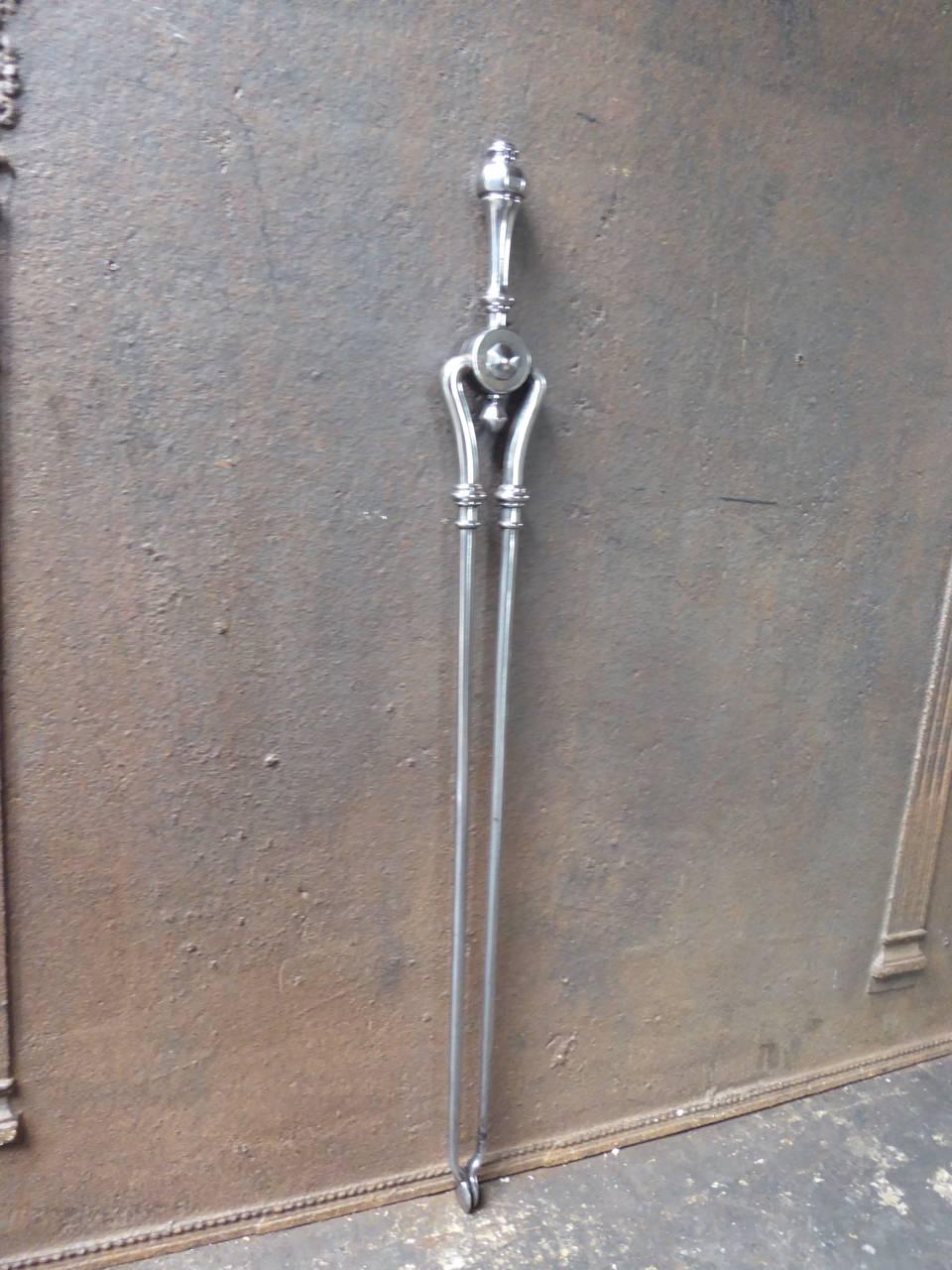 19th century English fire tongs made of polished steel.

We have a unique and specialized collection of antique and used fireplace accessories consisting of more than 1000 listings at 1stdibs. Amongst others we always have 300+ firebacks, 250+ pairs