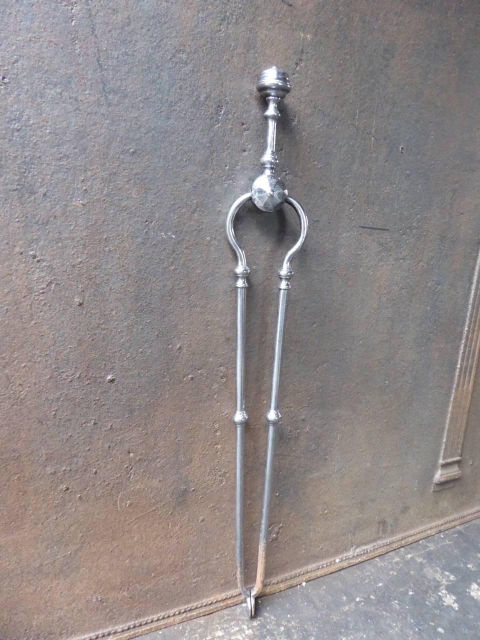 19th century English fire tongs made of polished steel.