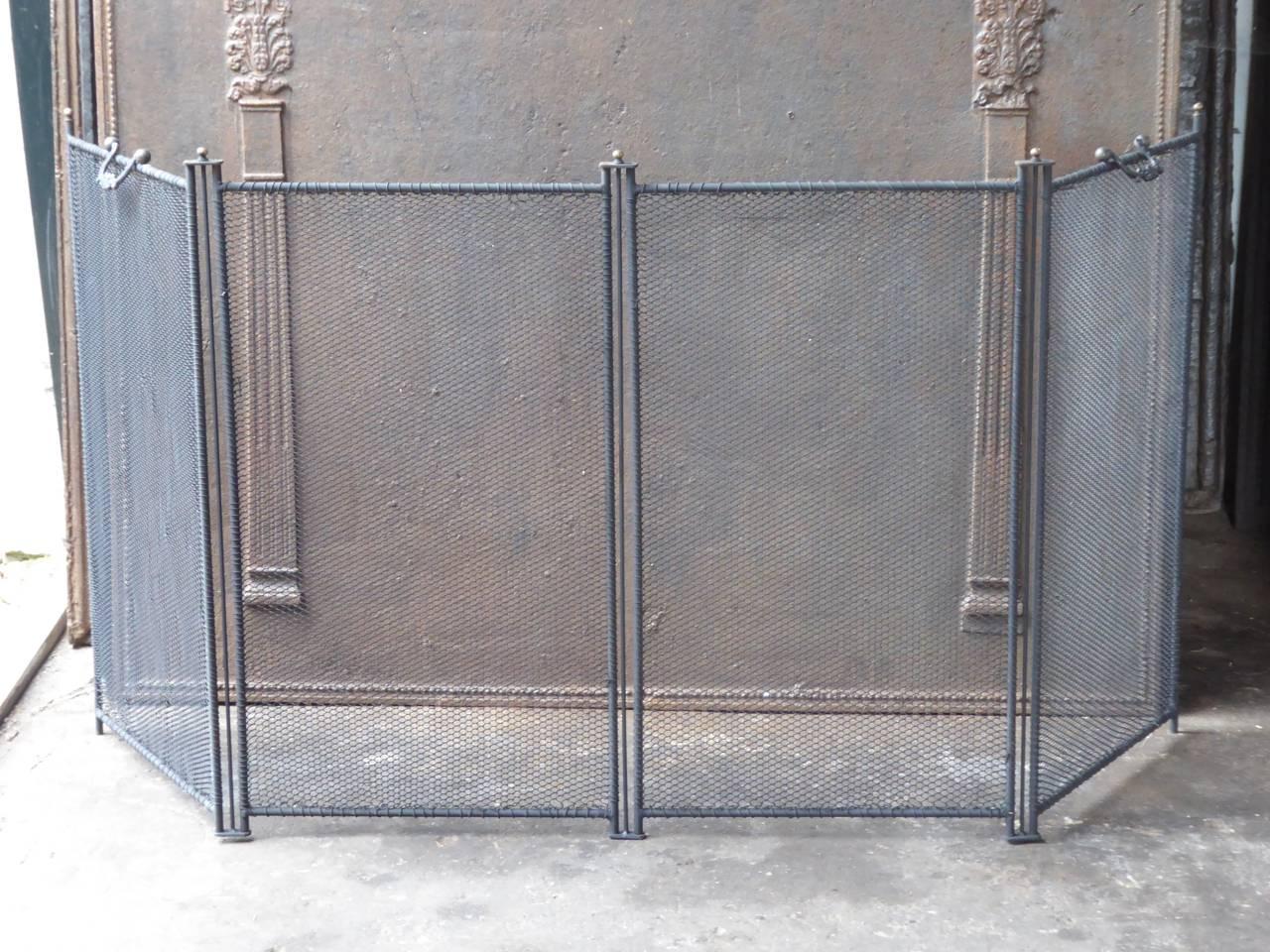 Replica of an antique original. Produced exactly as it used to be made and they are thus difficult to distinguish from an old original. 

With a Classic handle.

Important advantage of this type of fire screen is that, while elegant, you don't