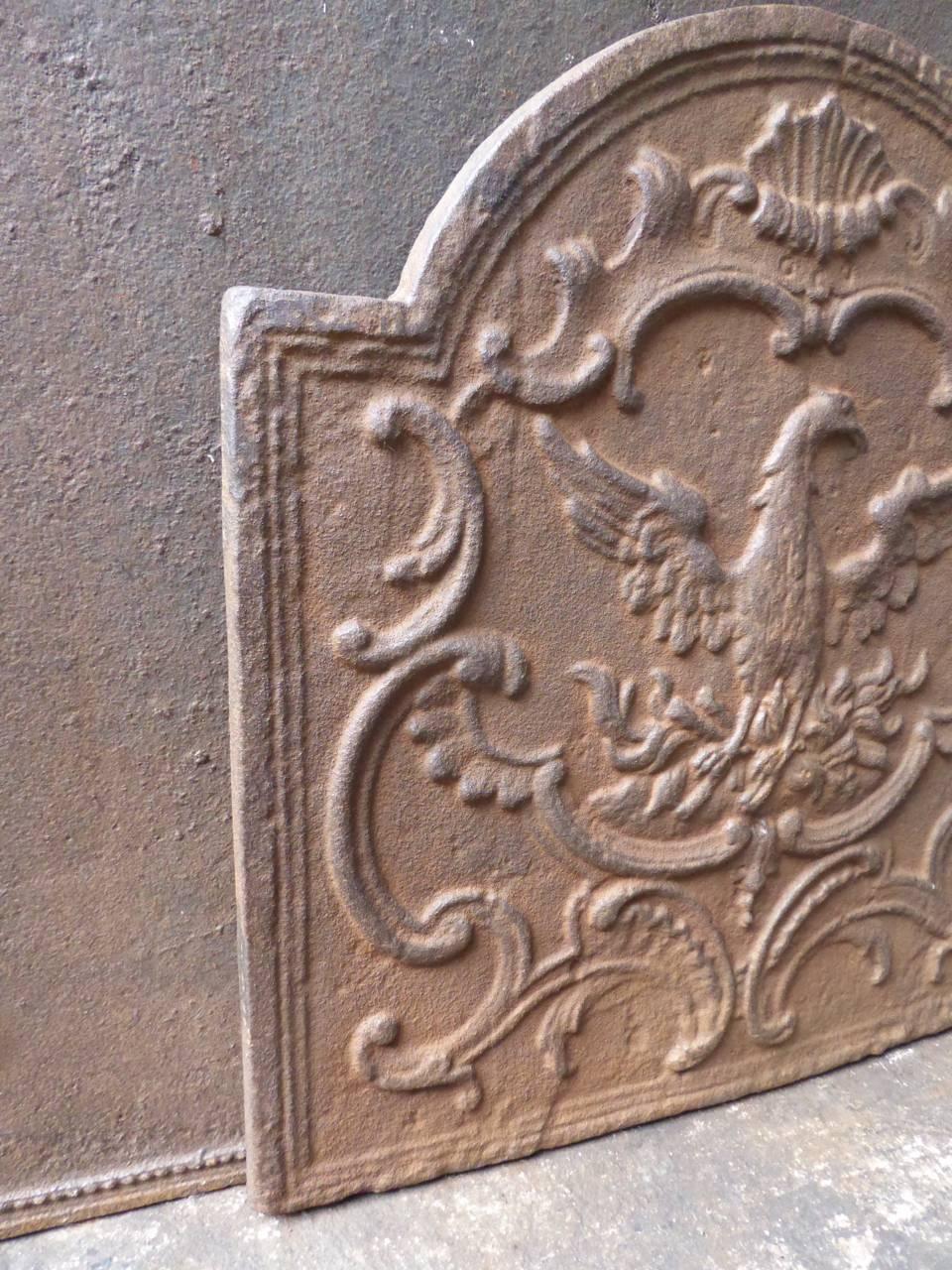 French Rococo style fireback with a Phoenix. The mythical bird who rises from its ashes.