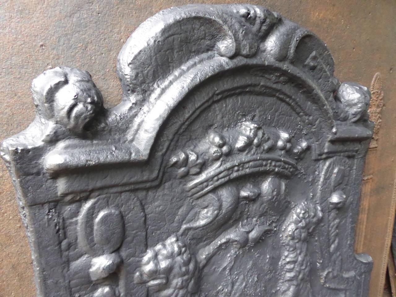 French fireback with a coat of arms. Two lions are carrying a shield and a crown.

We have a unique and specialized collection of antique and used fireplace accessories consisting of more than 1000 listings at 1stdibs. Amongst others we always have