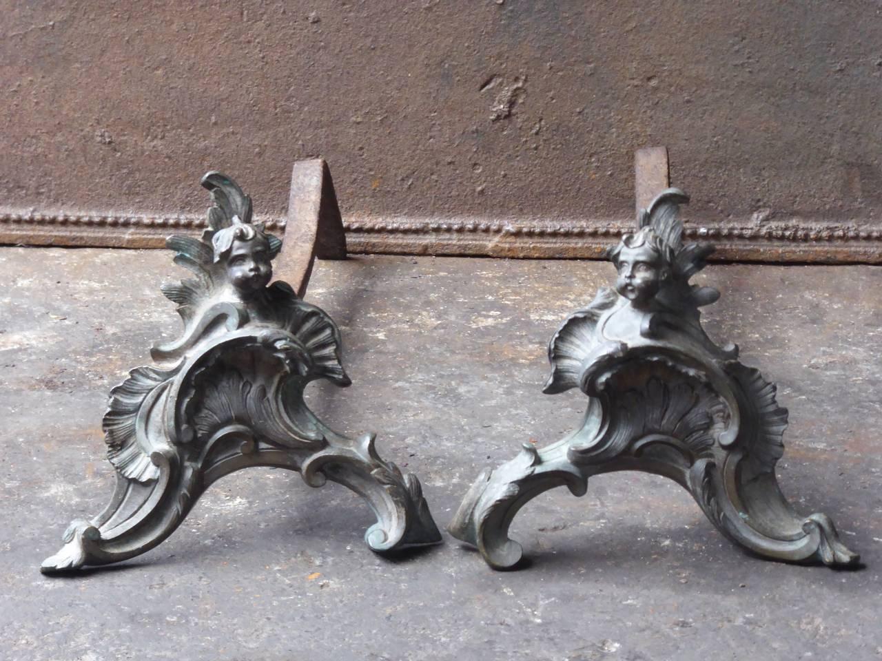 French Louis XV style firedogs made of brass and wrought iron.