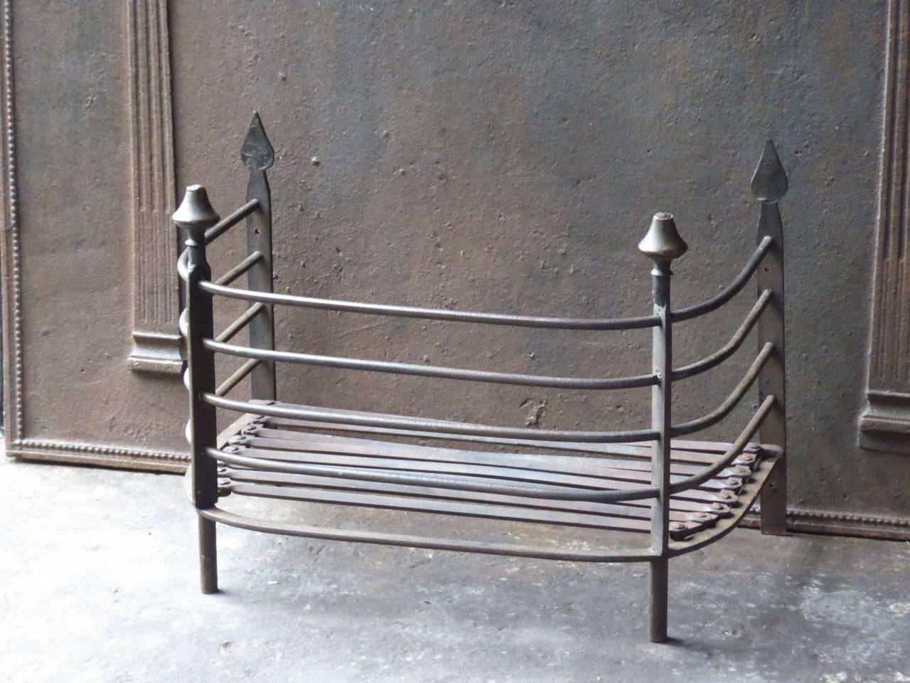 19th century Dutch fireplace grate made of wrought iron and brass.
