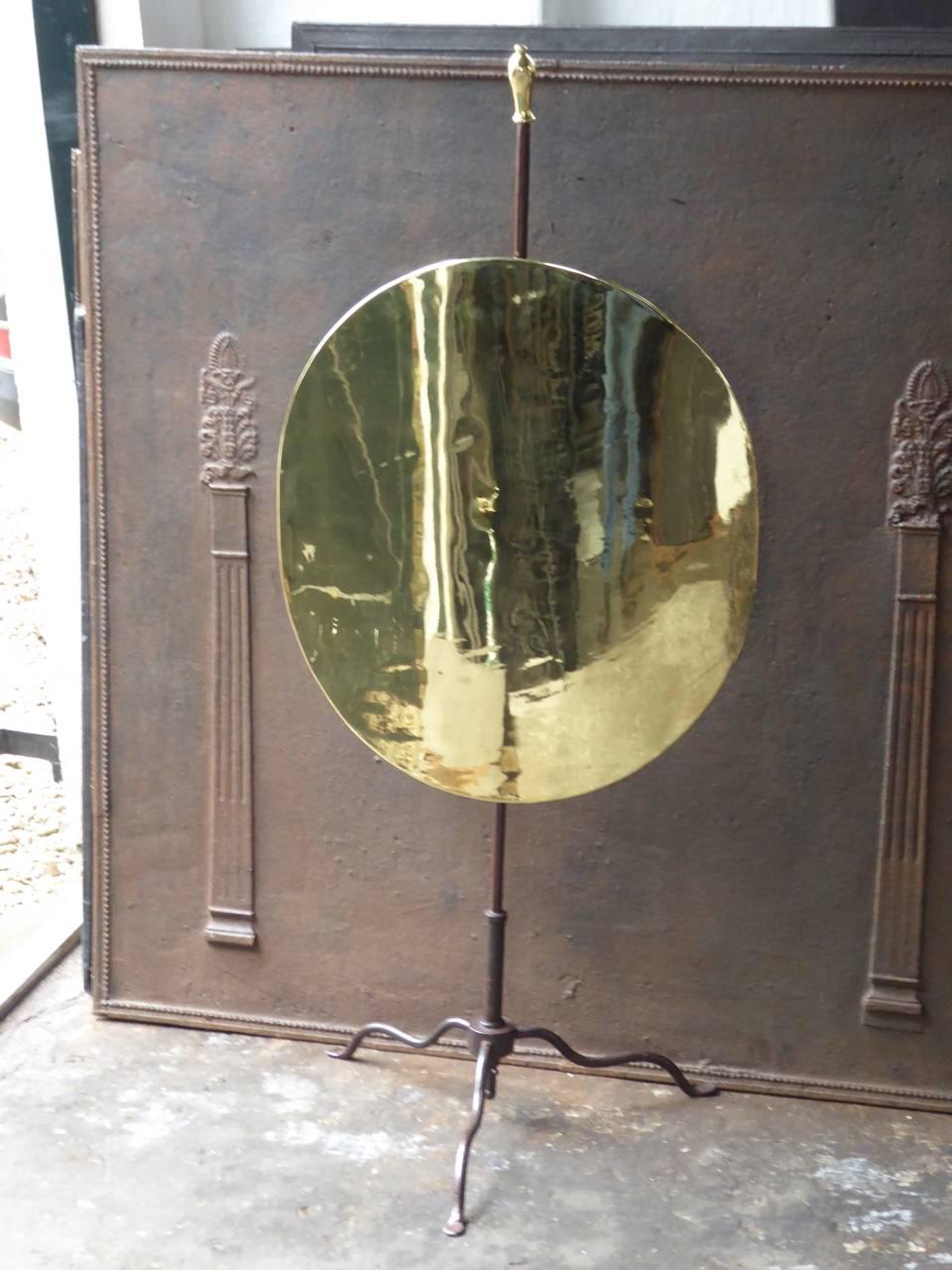 19th century French fire screen made of polished brass and wrought iron.