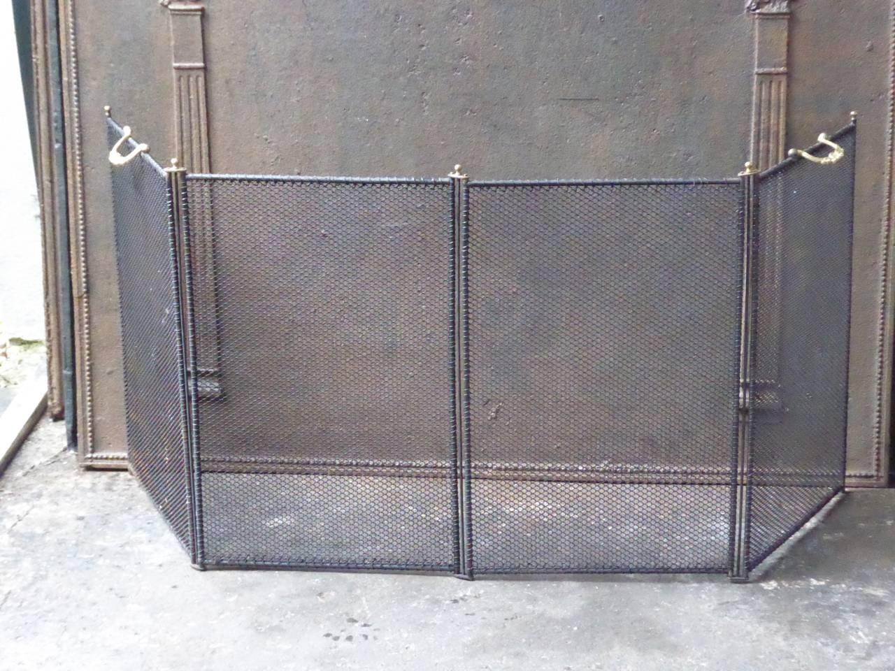 French 19th-20th century fire screen made of wrought iron with iron mesh and brass handles.