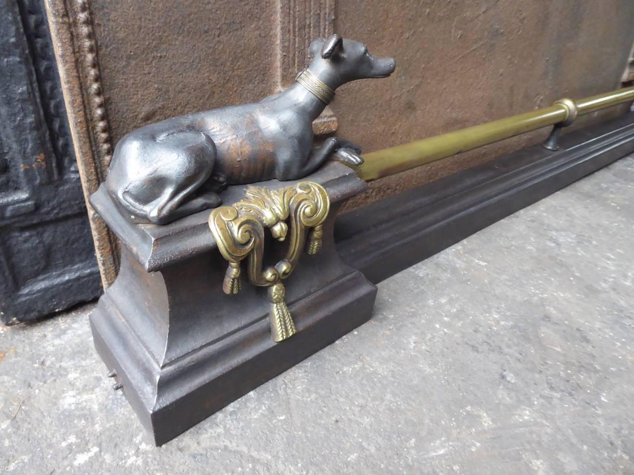 19th century French fireplace fender made of wrought iron and brass.