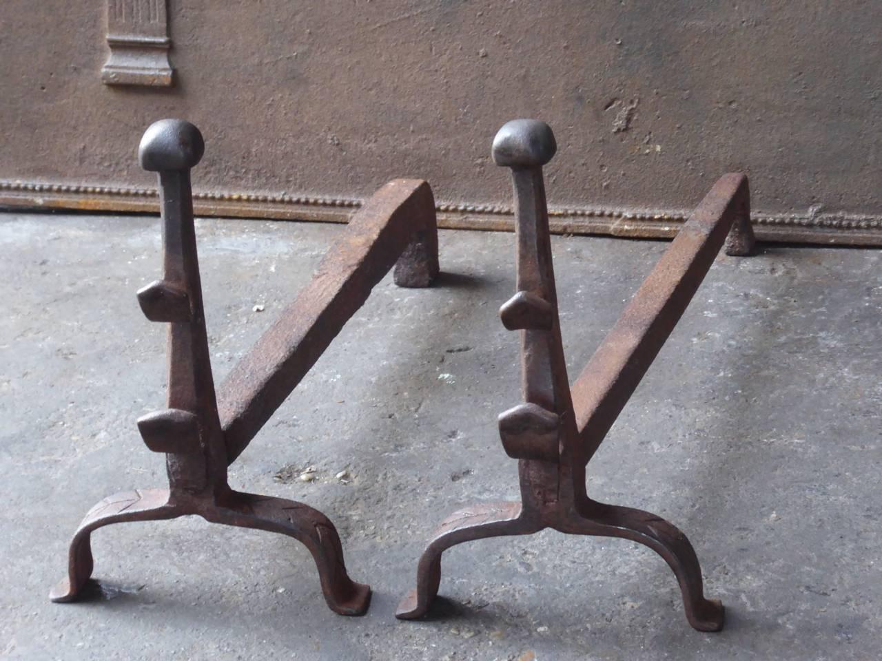 18th century French Gothic style fire dogs made of wrought iron. The firedogs have spit hooks to grill food before the fire.

We have a unique and specialized collection of antique and used fireplace accessories consisting of more than 1000 listings