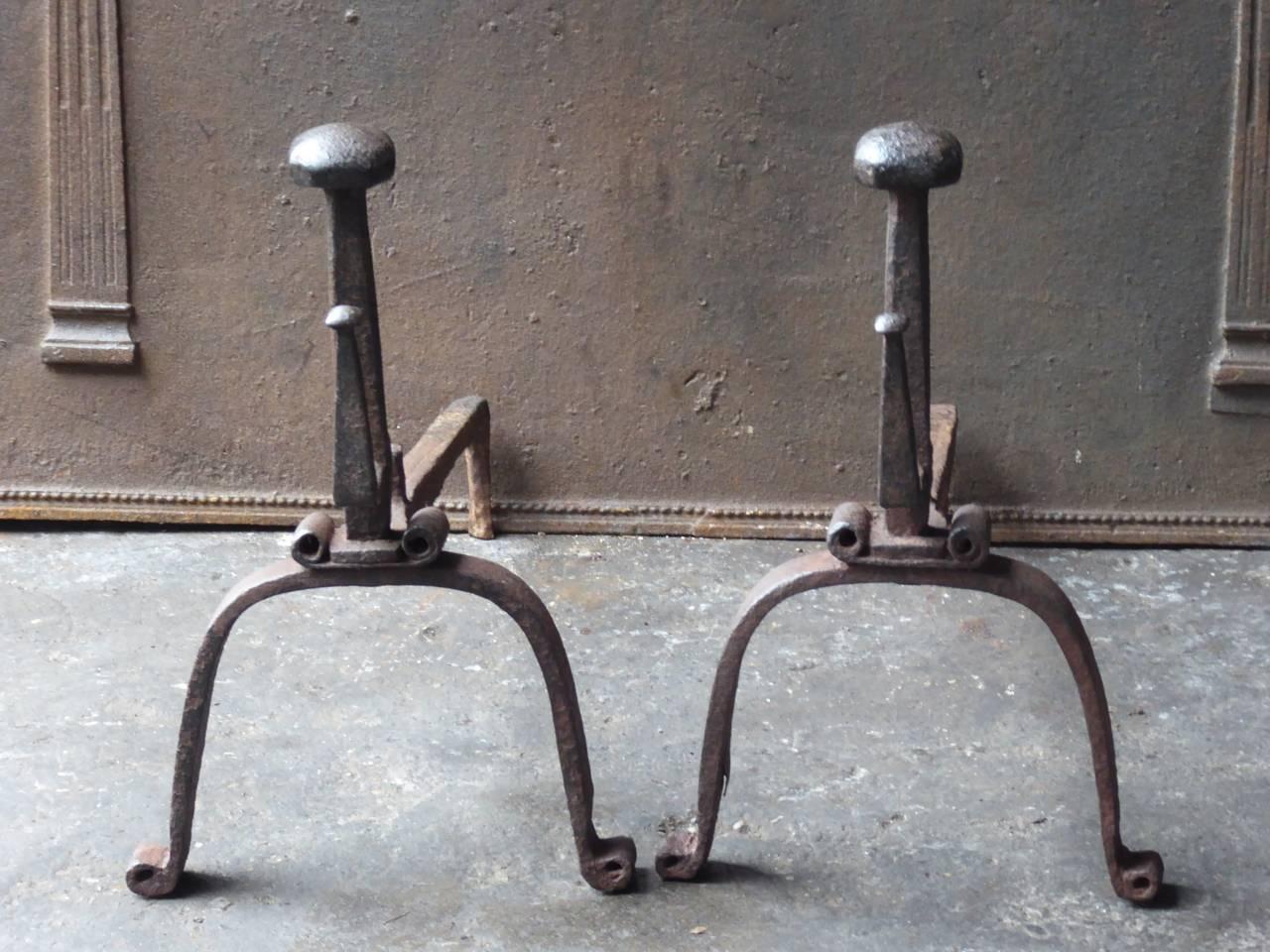 18th century Gothic style fire dogs made of wrought iron. The andirons have spit hooks to grill food.

We have a unique and specialized collection of antique and used fireplace accessories consisting of more than 1000 listings at 1stdibs. Amongst