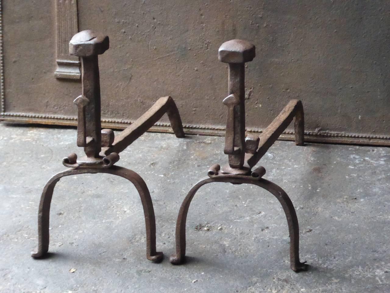 18th century French Louis XV period fire dogs made of wrought iron. The andirons have spit hooks to grill food. The condition is good.

