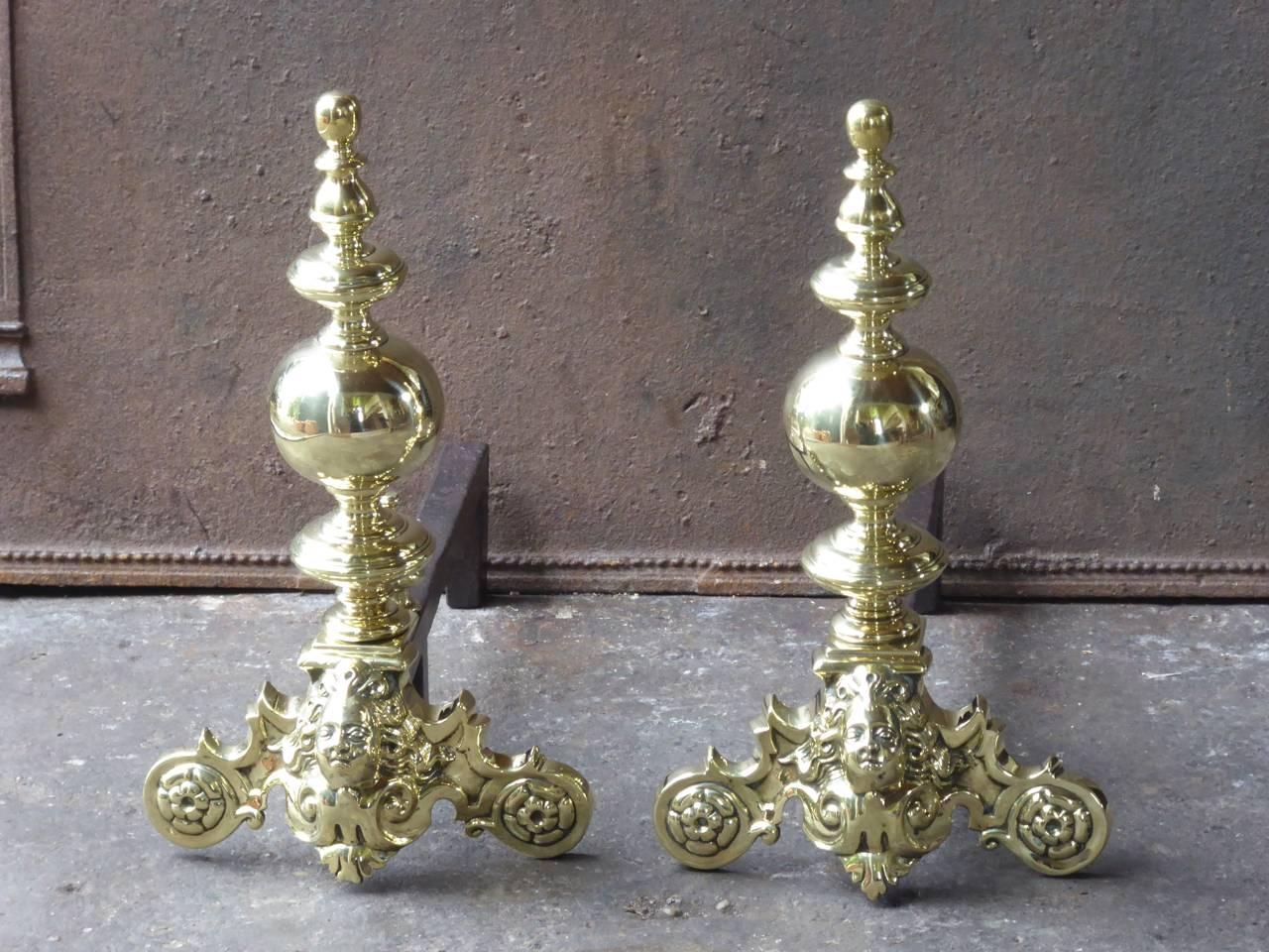 19th century Louis XIV style fire dogs made of polished brass and wrought iron.