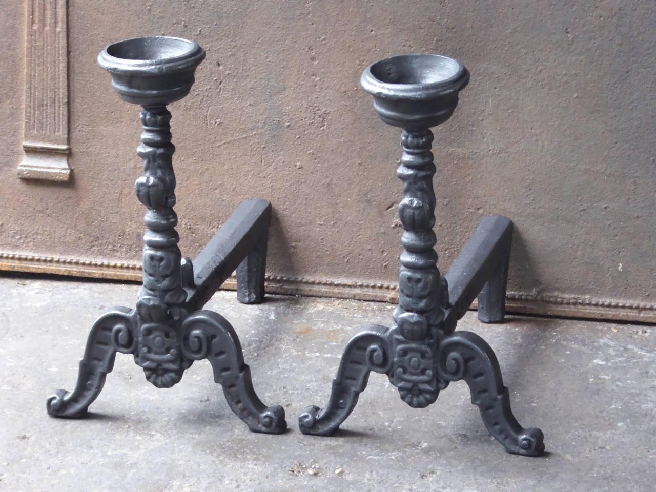 French andirons made of cast iron. With spit hooks to grill food and a cup to keep drinks or soup warm. This type of andirons is also called cup dogs.