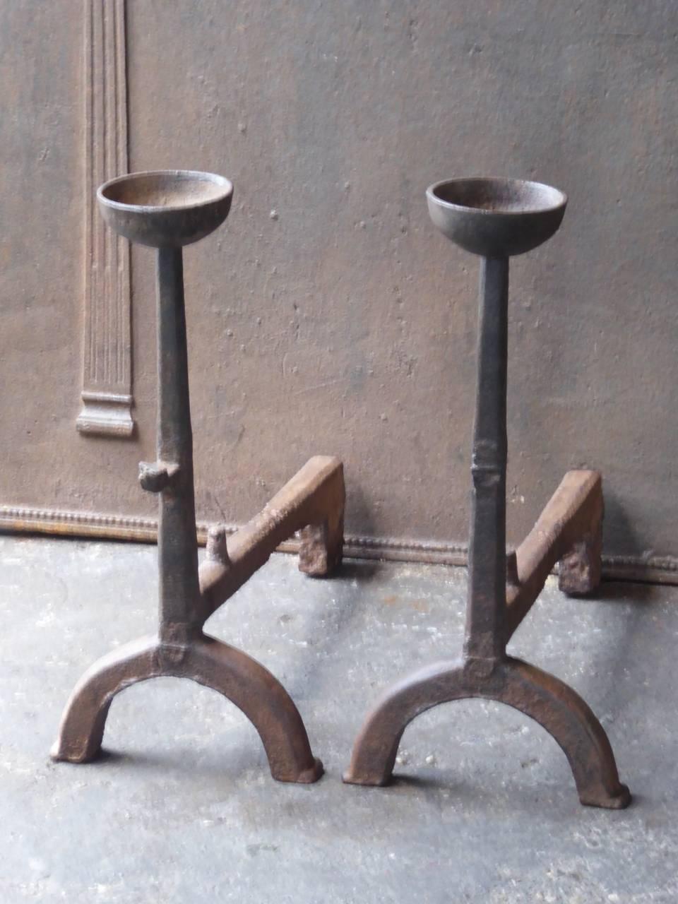 French Gothic style andirons made of cast iron. With a cup to keep drinks or soup warm. This type of fire dogs is also called cup dogs.

We have a unique and specialized collection of antique and used fireplace accessories consisting of more than