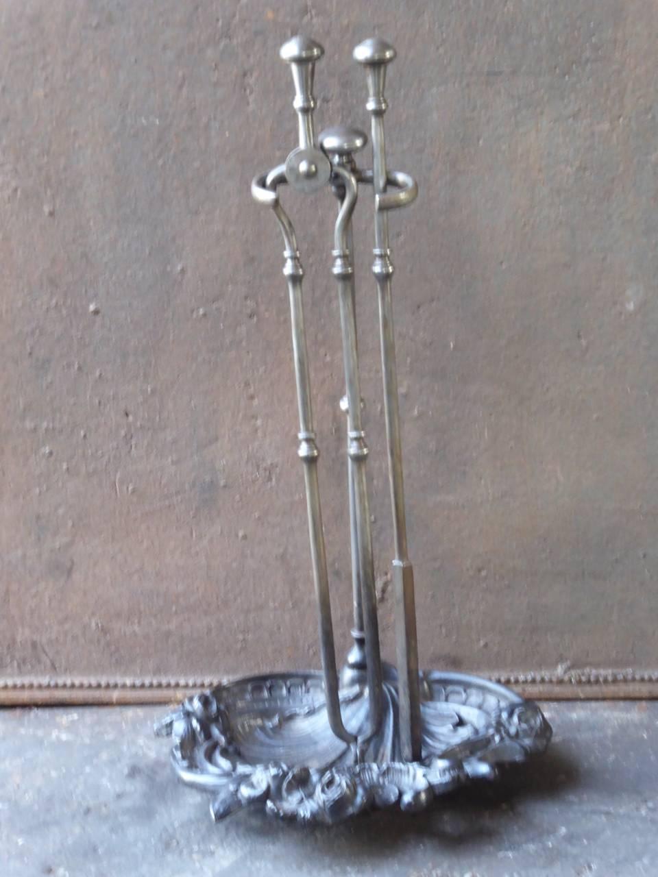 Late 18th or early 19th century English fireplace tool set - fire irons made of polished steel and cast iron. The style is Georgian and it is from that period. The condition is good.

