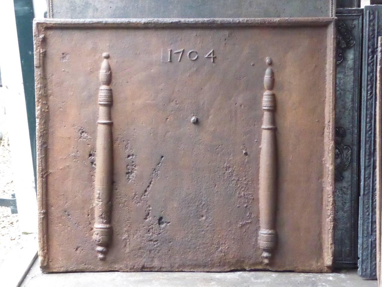 18th century French fireback with the Pillars of Hercules and the date of production 1704.

The pillar refers to the club of Hercules, his favourite weapon. It symbolizes power. Since antiquity the ‘Pillars of Hercules’ are also the name of the