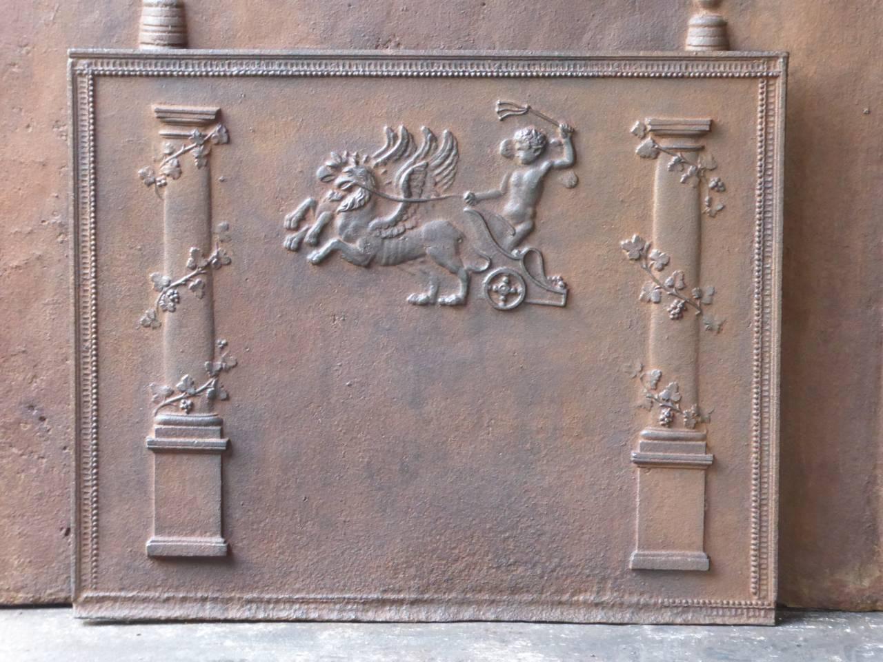 19th century fireback with two pillars and a boy who is riding two griffins. 

The griffin is a legendary creature which is partly an eagle and partly a lion. Because of these two animals, it is supposed to be a superior creature. Griffins are