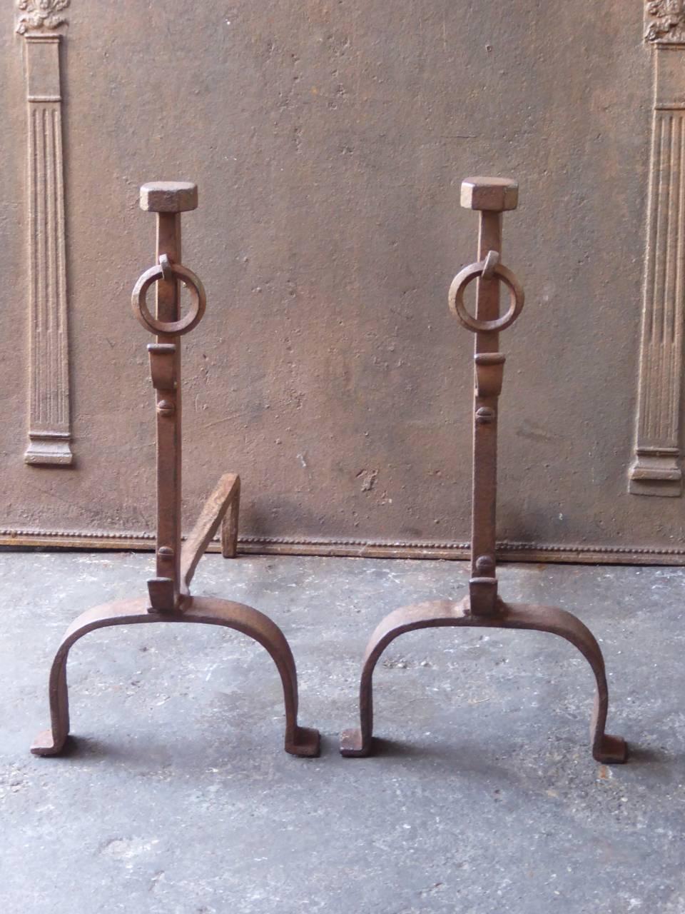 19th century French fire dogs made of wrought iron. The andirons have spit hooks to grill food.

We have a unique and specialized collection of antique and used fireplace accessories consisting of more than 1000 listings at 1stdibs. Amongst others,