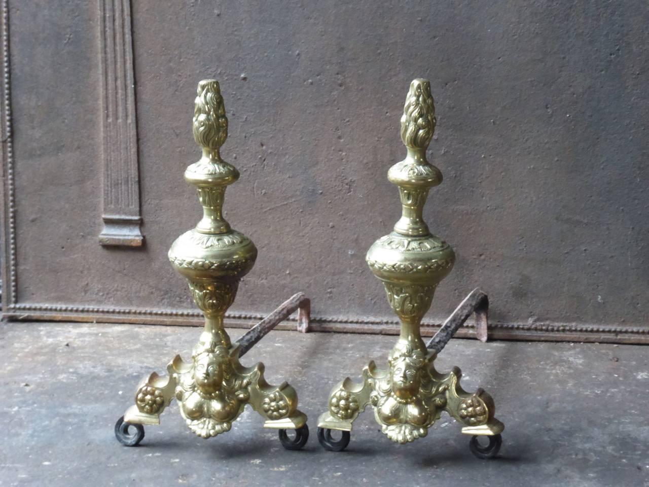 19th century French Louis XIV style fire dogs made of polished bronze and wrought iron.

The condition is good.