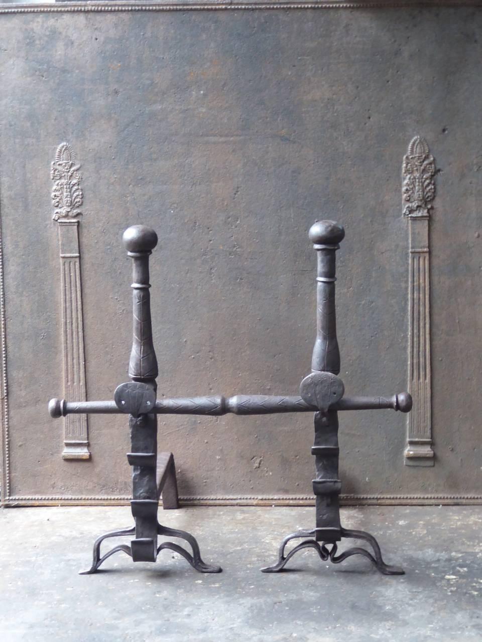 17th century French Louis XIII fire dogs made of wrought iron and bronze. These French andirons are called 'landiers' in France. This dates from the times the andirons were the main cooking equipment in the house. They had spit hooks to grill meat