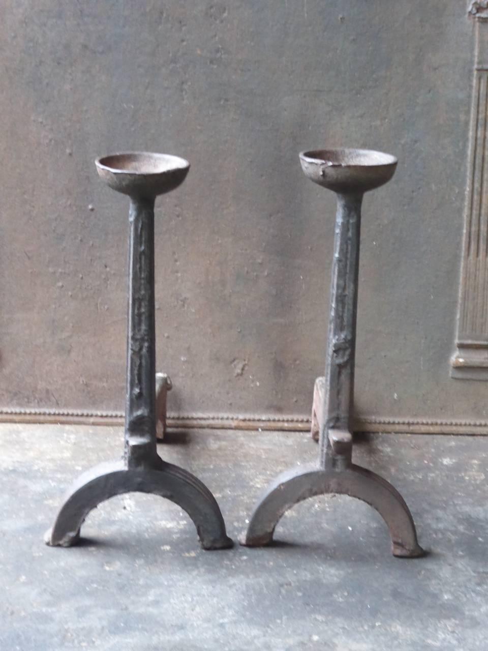 17th century French Gothic fire dogs made of cast iron. This type of andirons are also called cup dogs. The condition is good.

