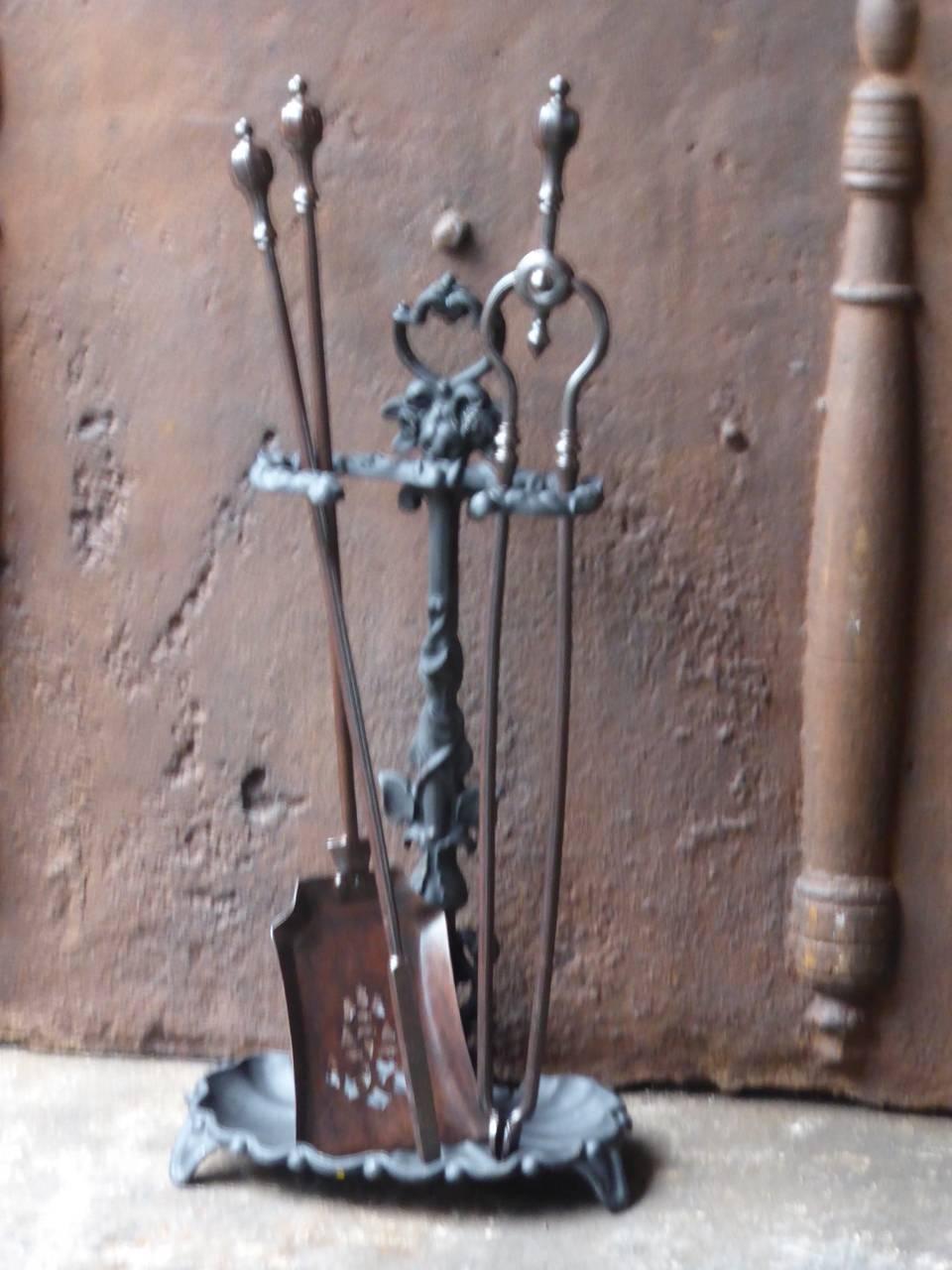 A set of victorian fire irons made of wrought iron with an ornate stand of cast iron.  The condition is good.

