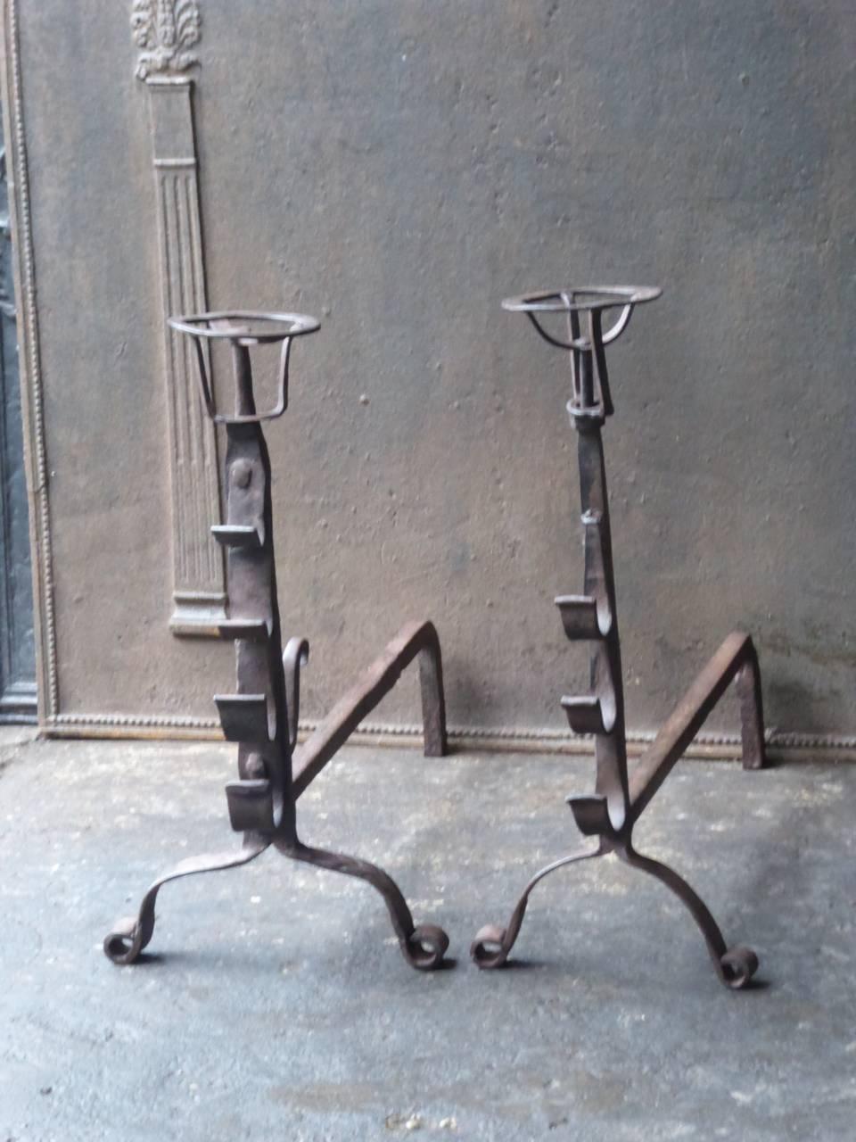 17th-18th century French Gothic fire dogs made of wrought iron. These French andirons are called 'landiers' in France. This dates from the times the andirons were the main cooking equipment in the house. They had spit hooks to grill meat or poultry