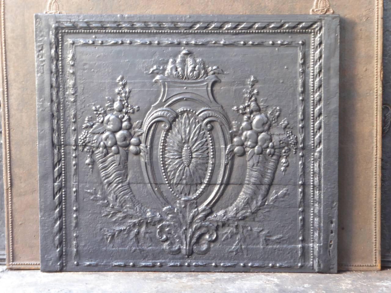 18th century French 'Fruits of the Summer' fireplace fireback. With two horns of plenty, a sunflower and other greenery.

We have a unique and specialized collection of antique and used fireplace accessories consisting of more than 1000 listings at