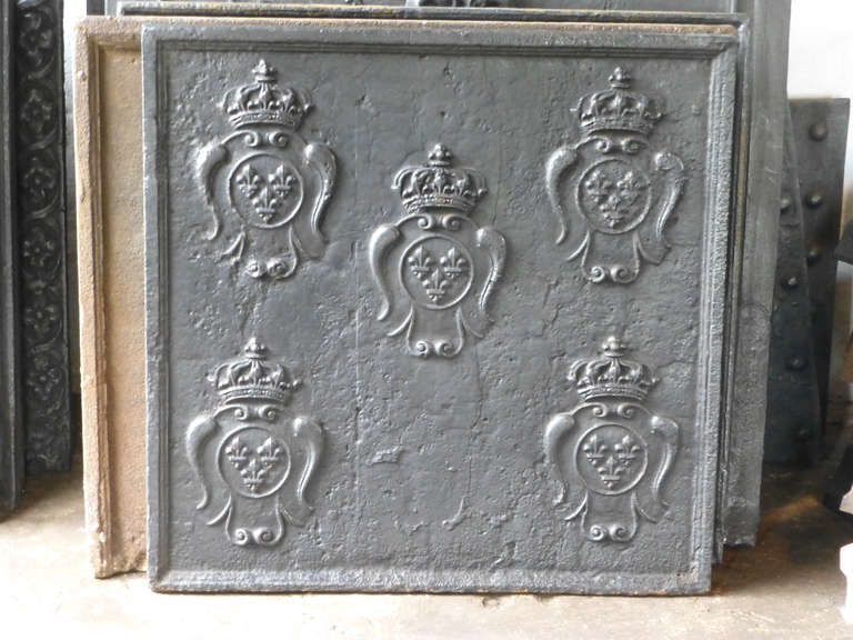 18th century fireback coats of arms of France. Each coat of arms has a crown and three Fleurs-de-Lys, all indicating royalty. The design of the coats of arms is of the period of Louis XV.

The fireback is made of cast iron and has a black / pewter