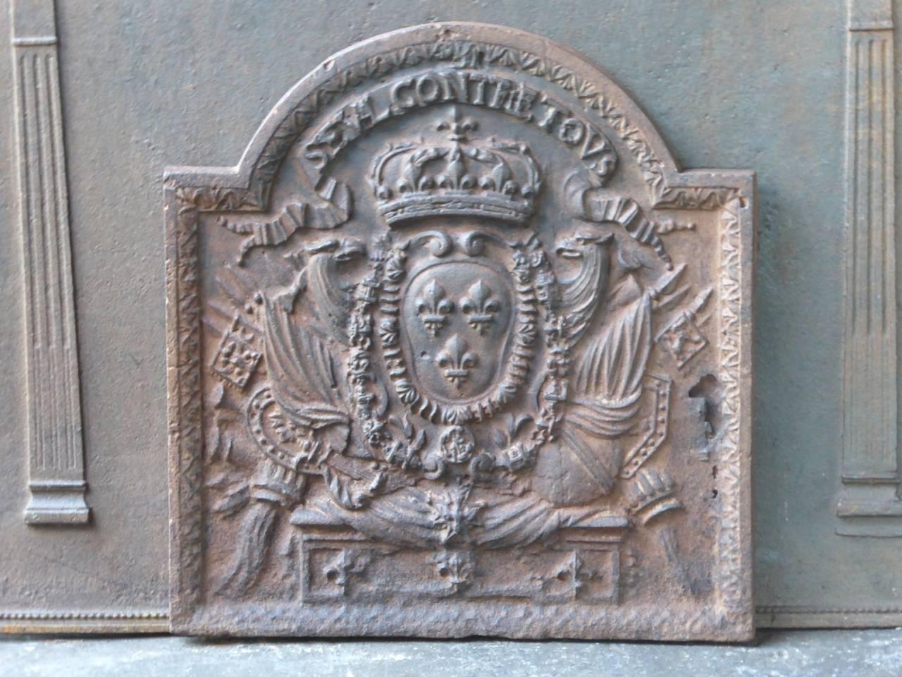 17th-18th century French fireback with the arms of France. Reminder plate that says Seul contre Tous, or 