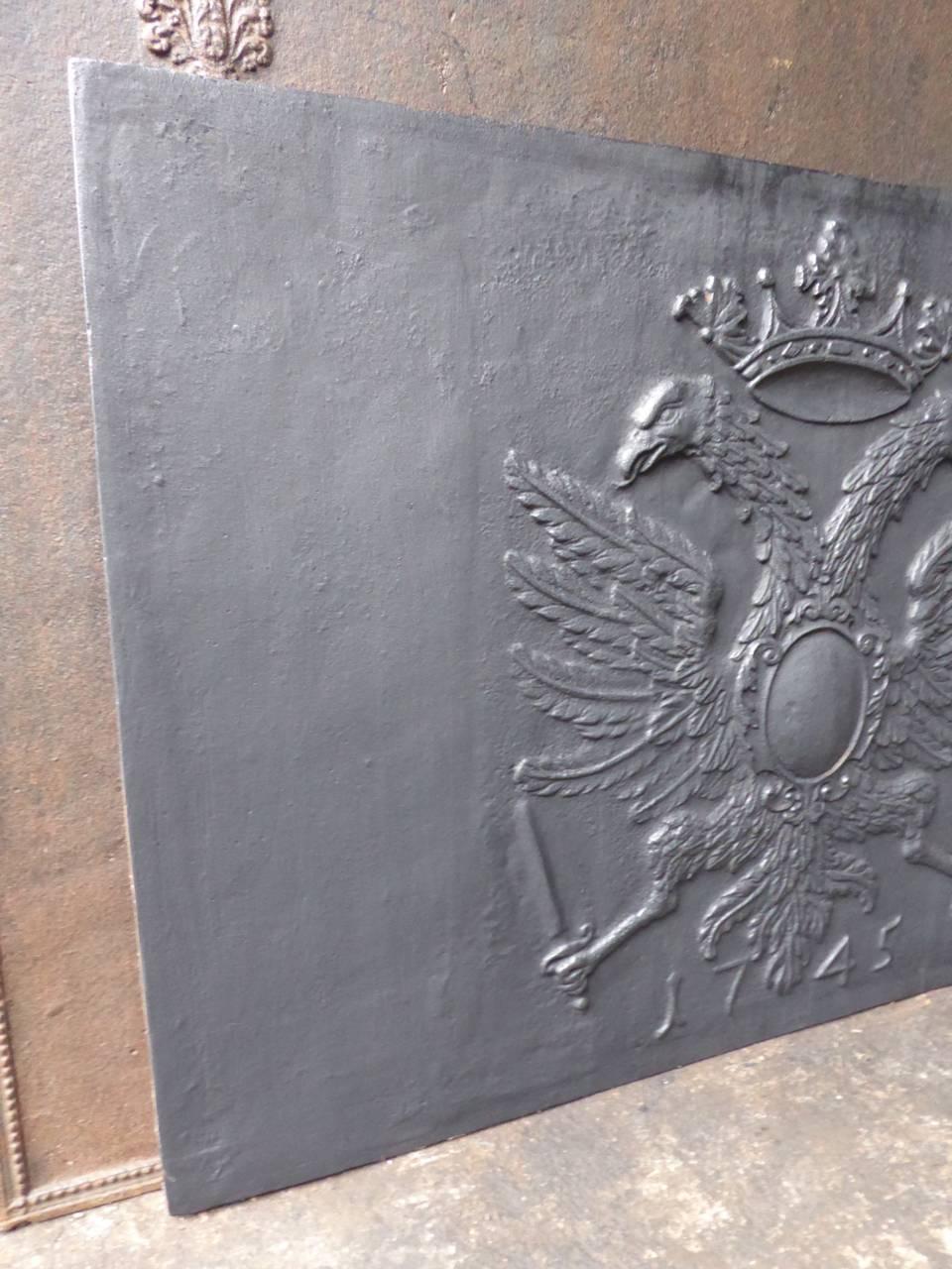 Fireback with a coat of arms consisting of two eagles and a crown.

We have a unique and specialized collection of antique and used fireplace accessories consisting of more than 1000 listings at 1stdibs. Amongst others we always have 300+