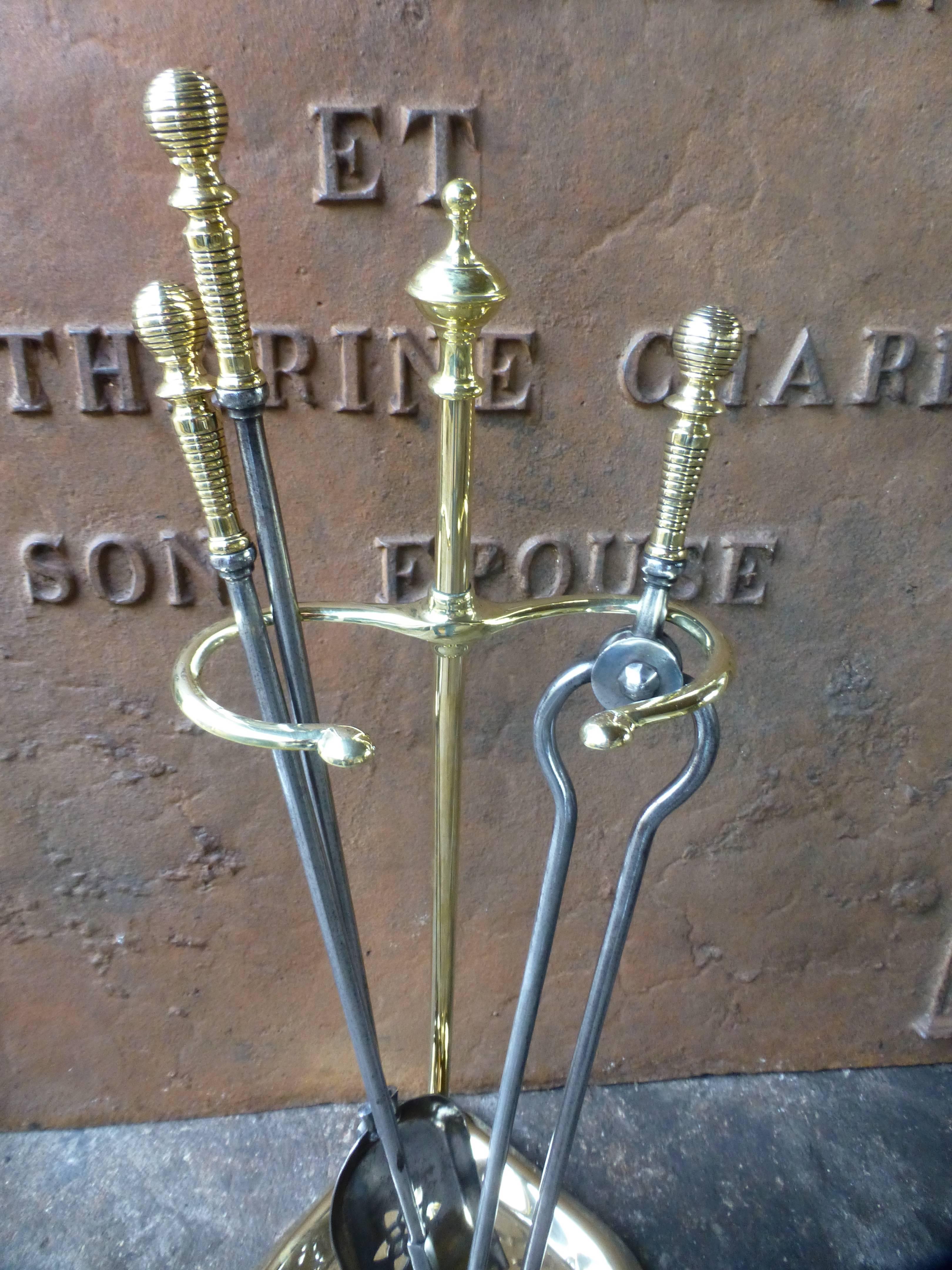 19th century polished steel and brass fire tool set.








 