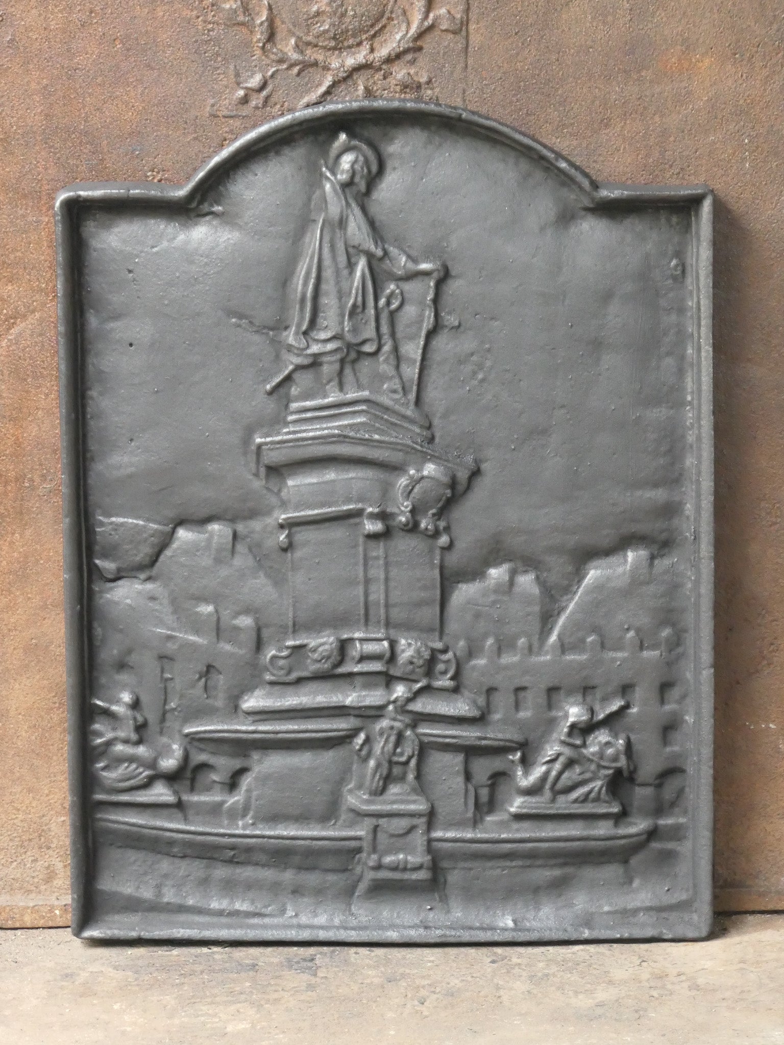 19th-20th century French Napoleon III fireback with D'Artagnan. D'Artagnan is the best known hero of the Three Musketeers. 

The fireback is made of cast iron and has a black / pewter patina. It is in a good condition and does not have cracks.



   
