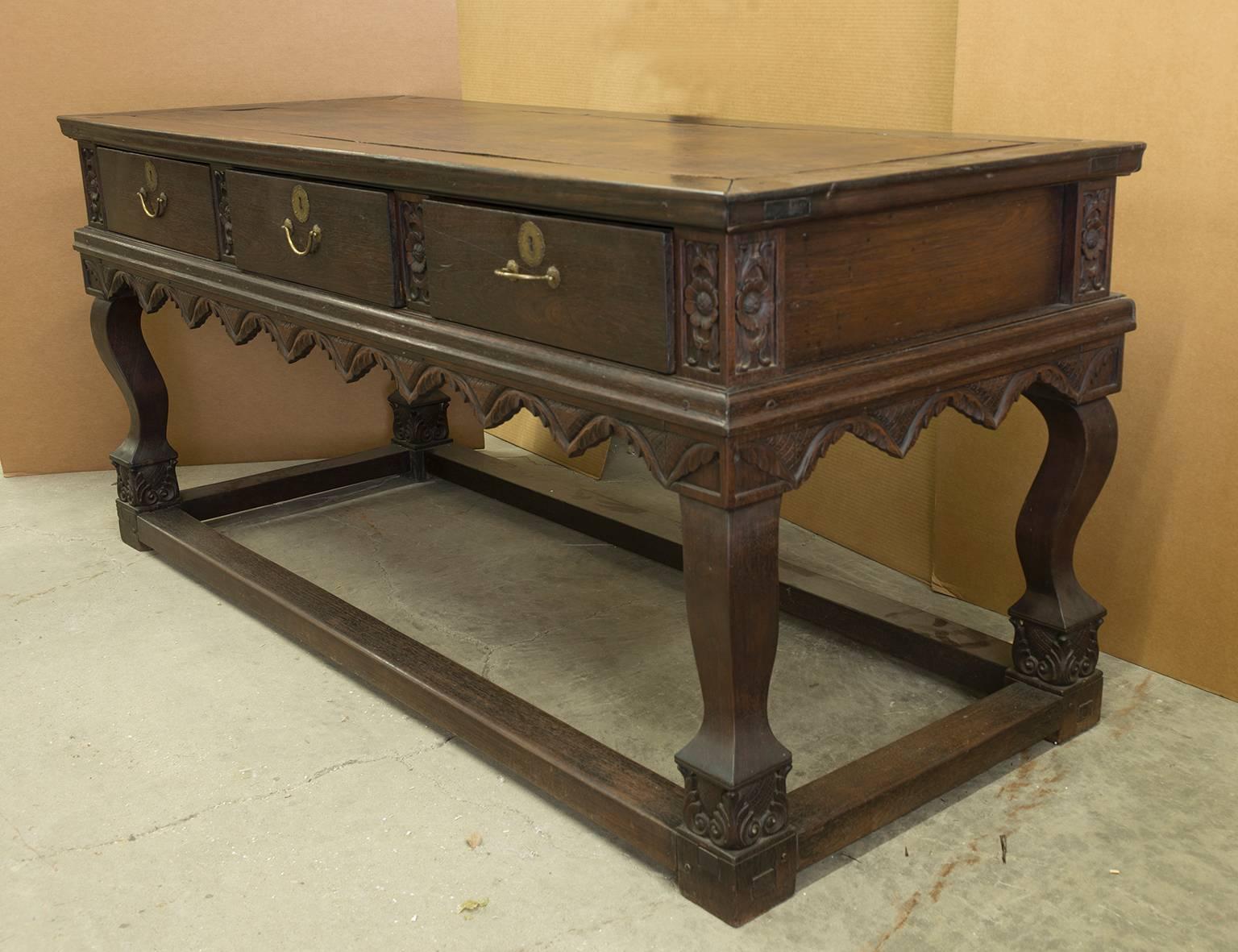This sideboard comes from Dutch Colonial Guyana. It features a pineapple motif on the feet and trim